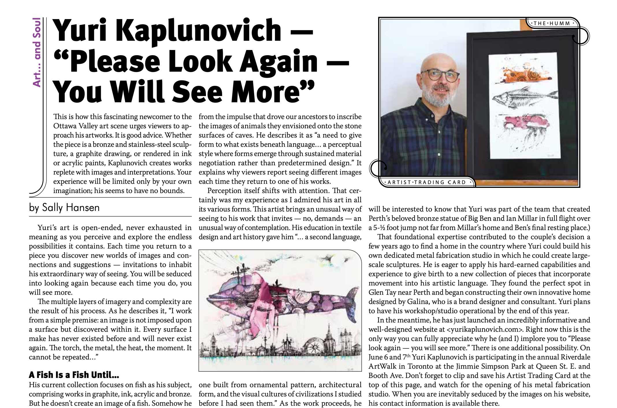 A man with glasses and a beard standing next to a framed artwork featuring colorful sketches of fish and a vehicle, in an art gallery setting.