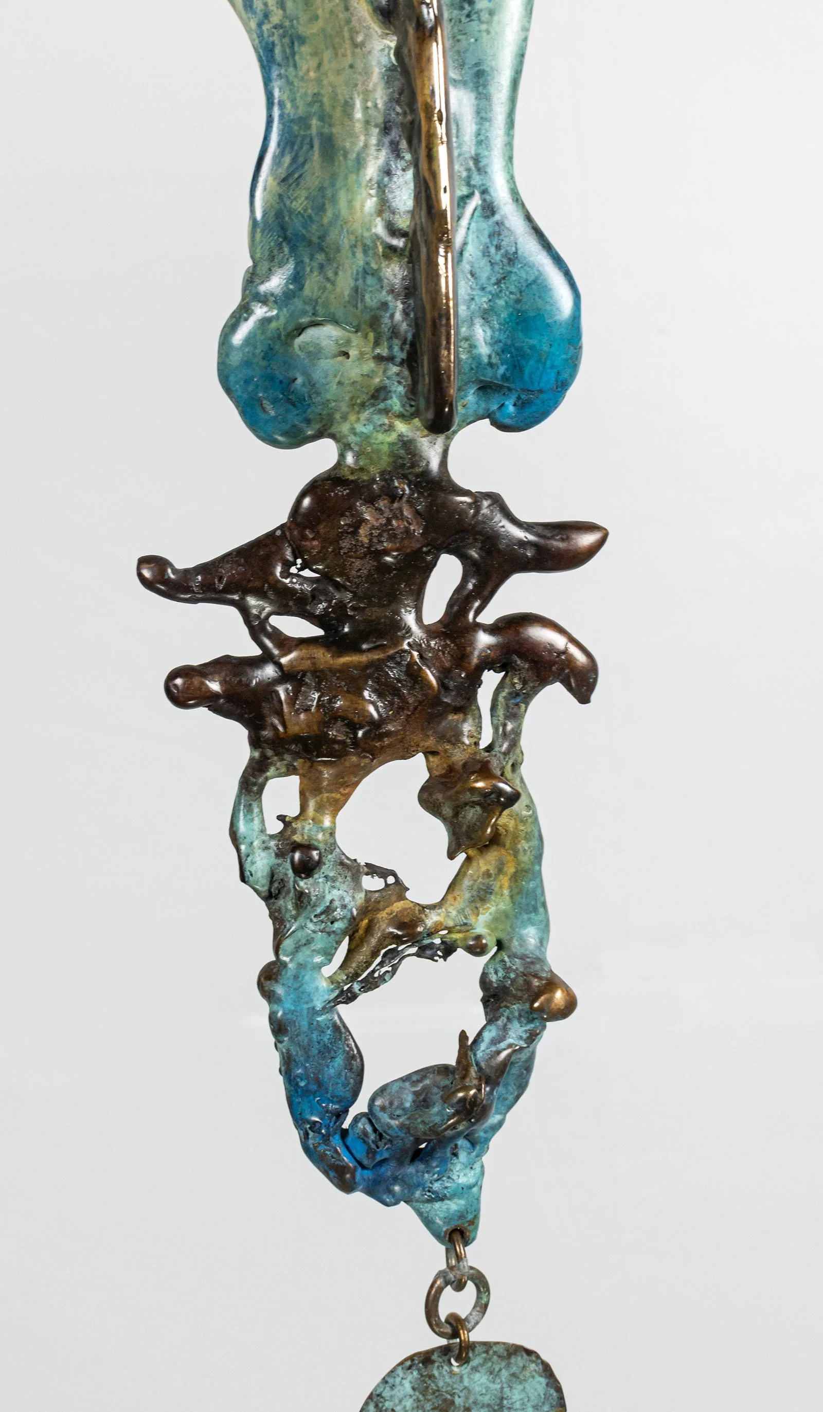Blue and verdigris patina emphasize the poured elements and bring the texture alive, gathering where the metal gathered and thinning where it thinned. 