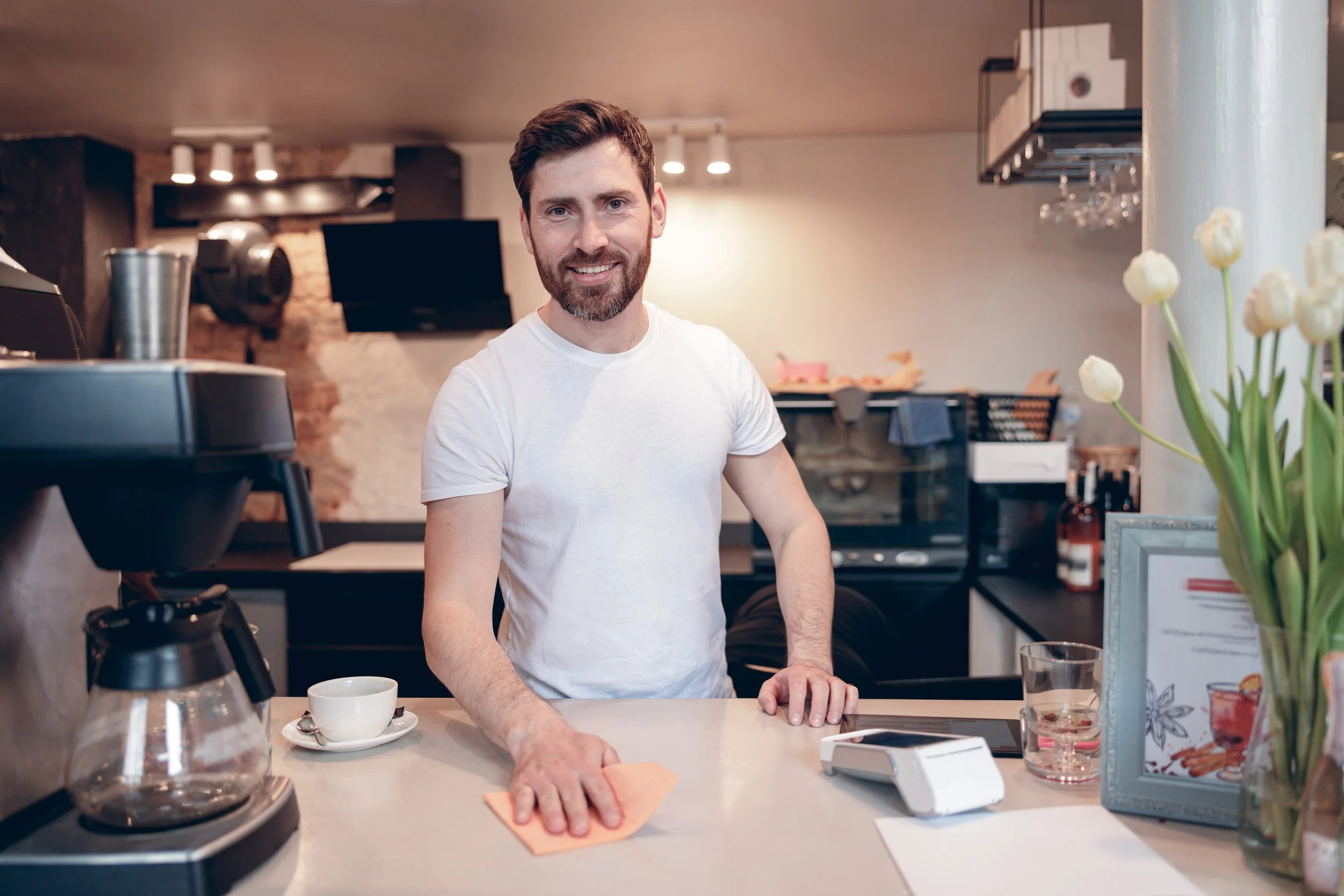 handsome-caucasian-happy-male-bartender-cleaning-c-2026-01-05-06-06-02-utc.jpg