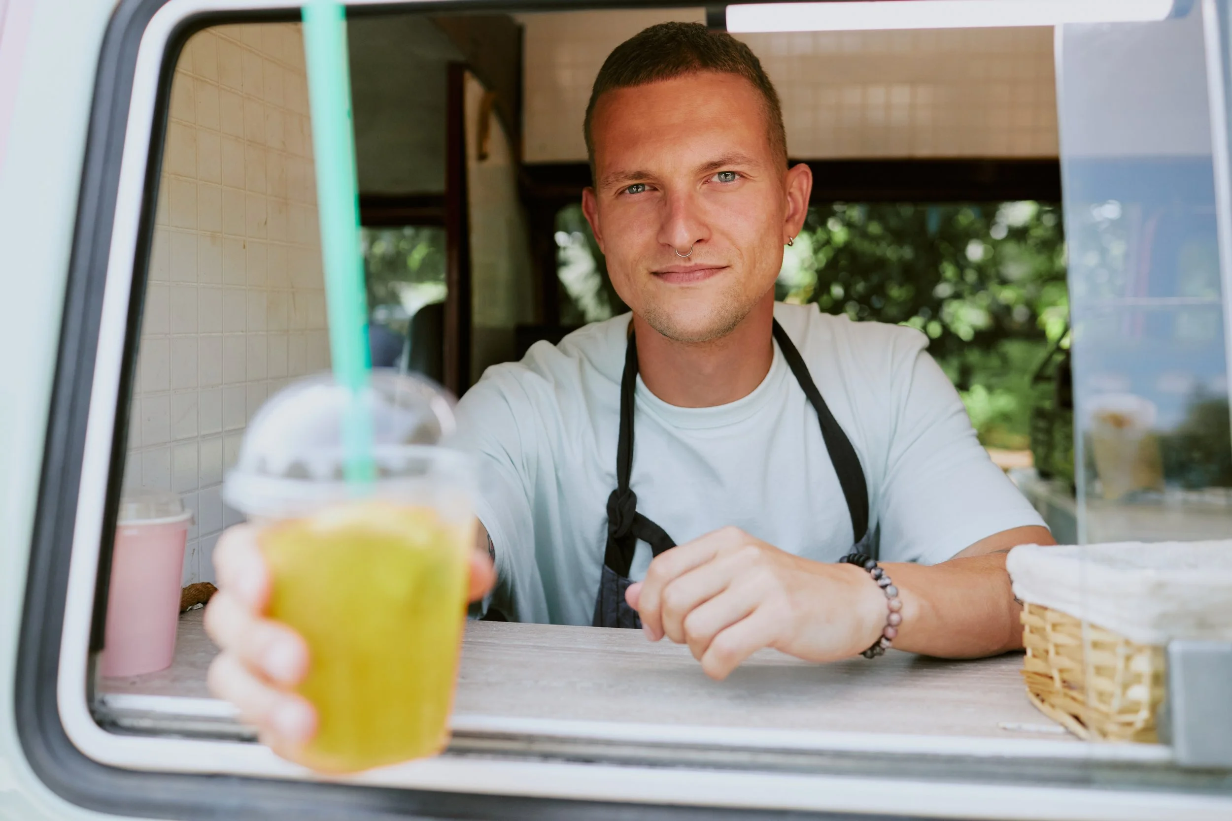 smiling-vendor-serving-refreshing-juice-drink-at-s-2026-01-09-06-41-57-utc.jpg