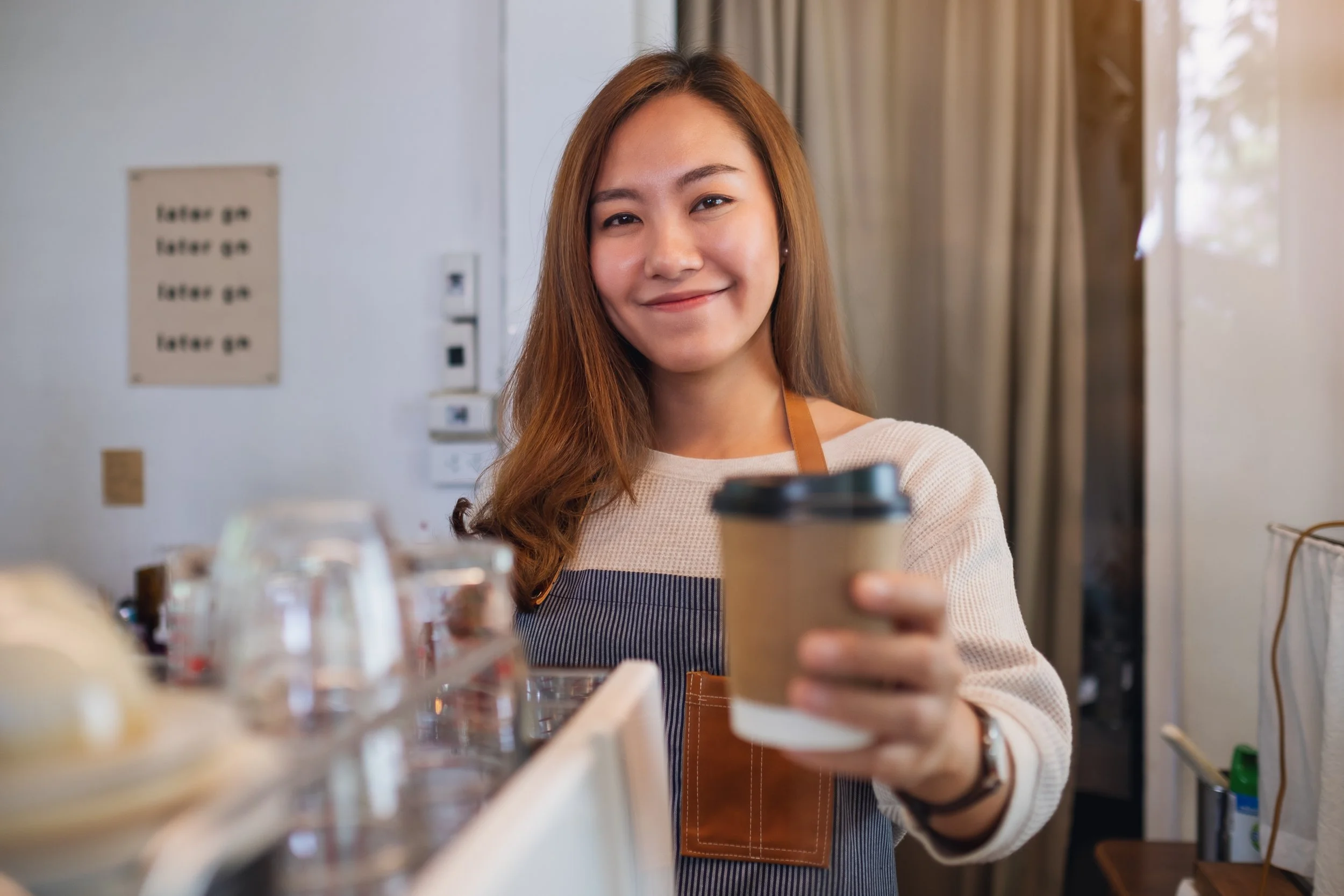 a-waitress-holding-and-serving-paper-cups-of-hot-c-2026-03-26-22-47-41-utc.jpg