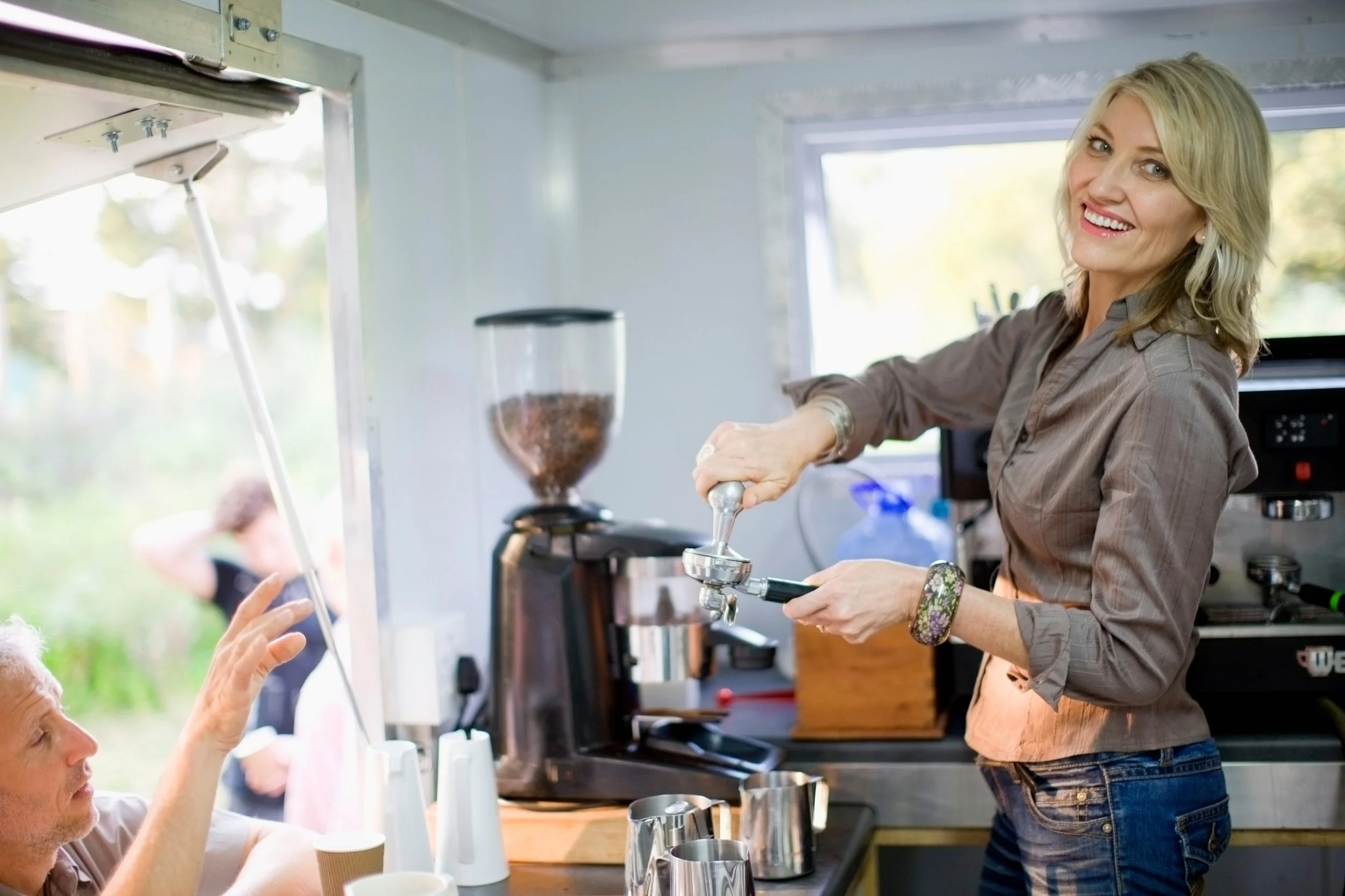 woman-makes-coffee-while-man-waits-at-counter-2026-01-11-10-31-53-utc.jpg