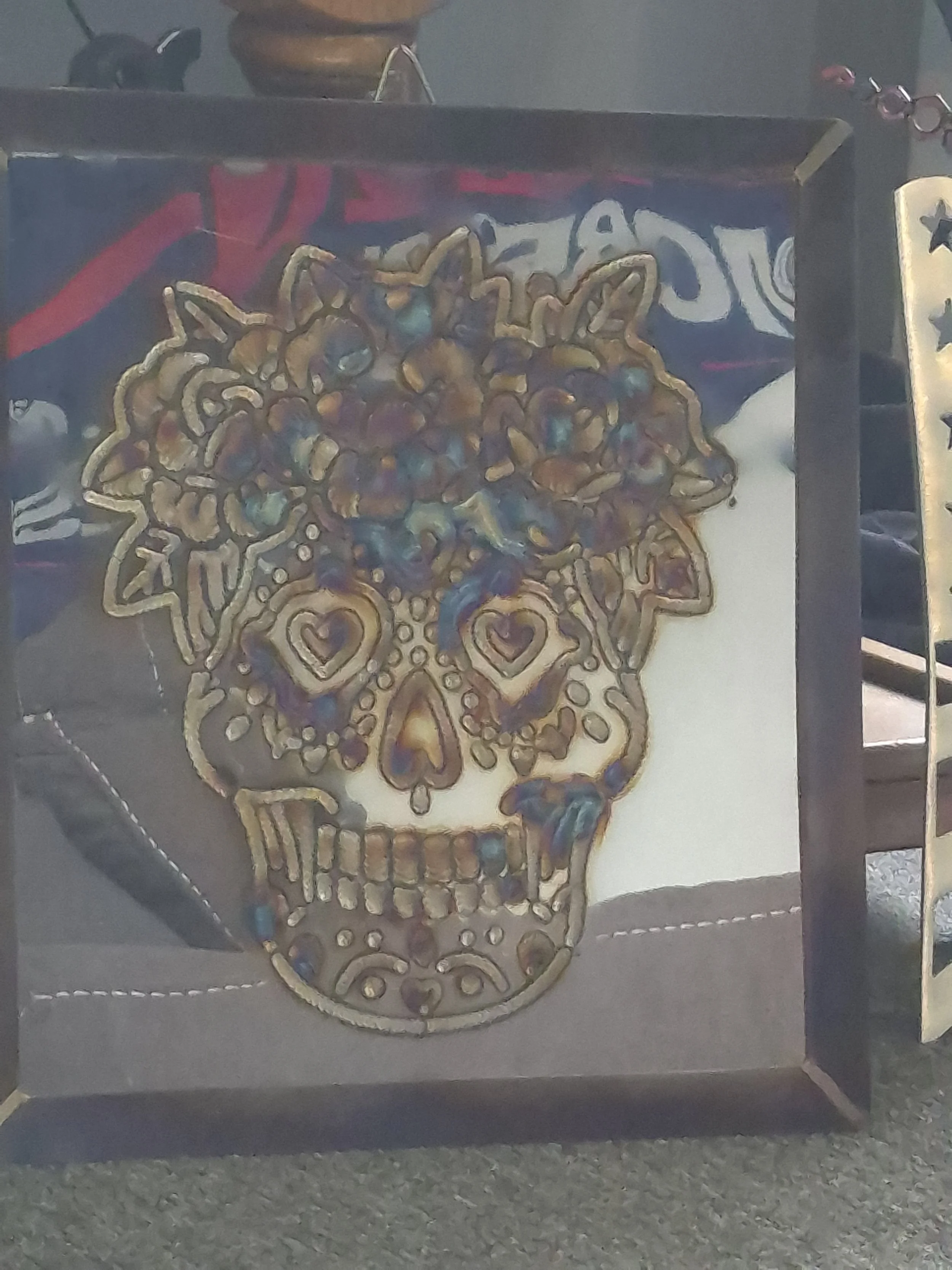 Floral Sugar Skull Metal Art - Handcrafted floral sugar skull design. This bold statement piece blends edgy artistry with intricate floral detailing, making it perfect for unique home decor. | Price: $425 | Quantity in stock: 1