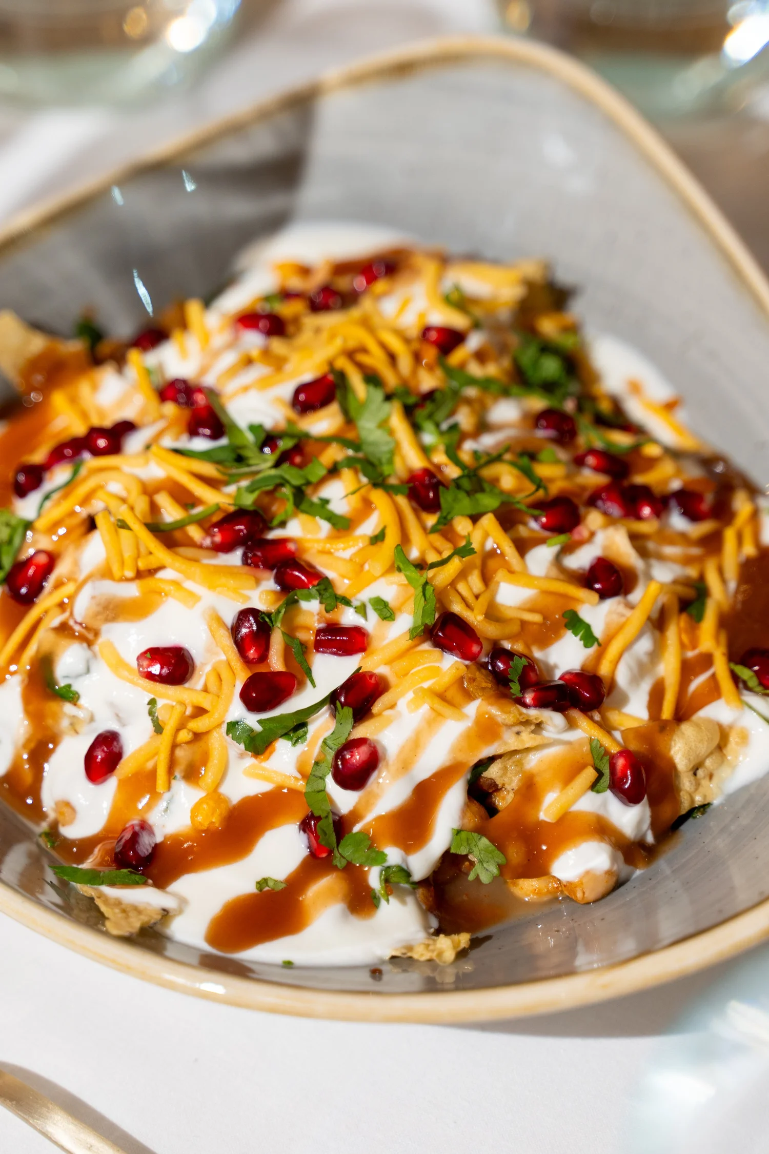 Chaat topped with yoghurt, herbs and pomegranate