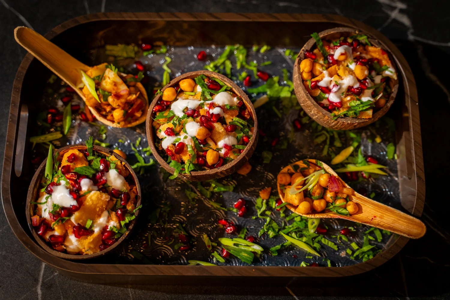 A selection of savoury dishes on a black tray