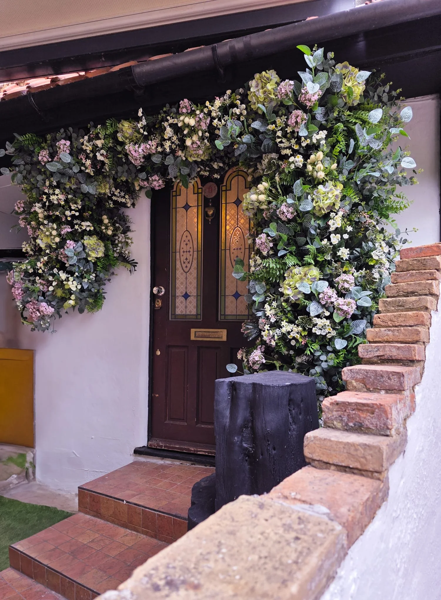 Outdoor entrance decorated with white flowers