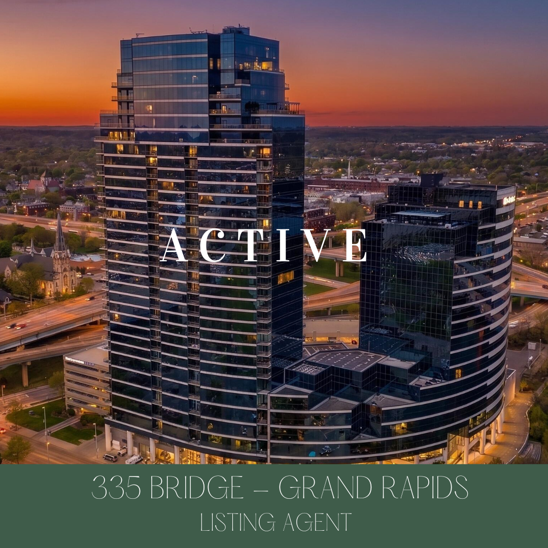 Aerial view of modern glass skyscrapers in downtown Grand Rapids at sunset, with the word 'ACTIVE' overlayed in the center and address '335 Bridge — Grand Rapids, Listing Agent' at the bottom.