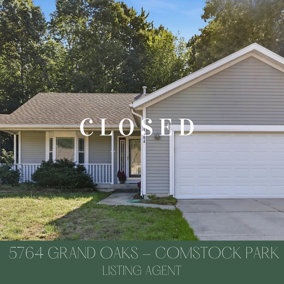 Front view of a gray house with a white garage door, a small porch with white railings, a concrete walkway, surrounded by green grass and trees in the background. The word 'CLOSED' is overlaid on the image. The house is located at 5764 Grand Oaks, Co