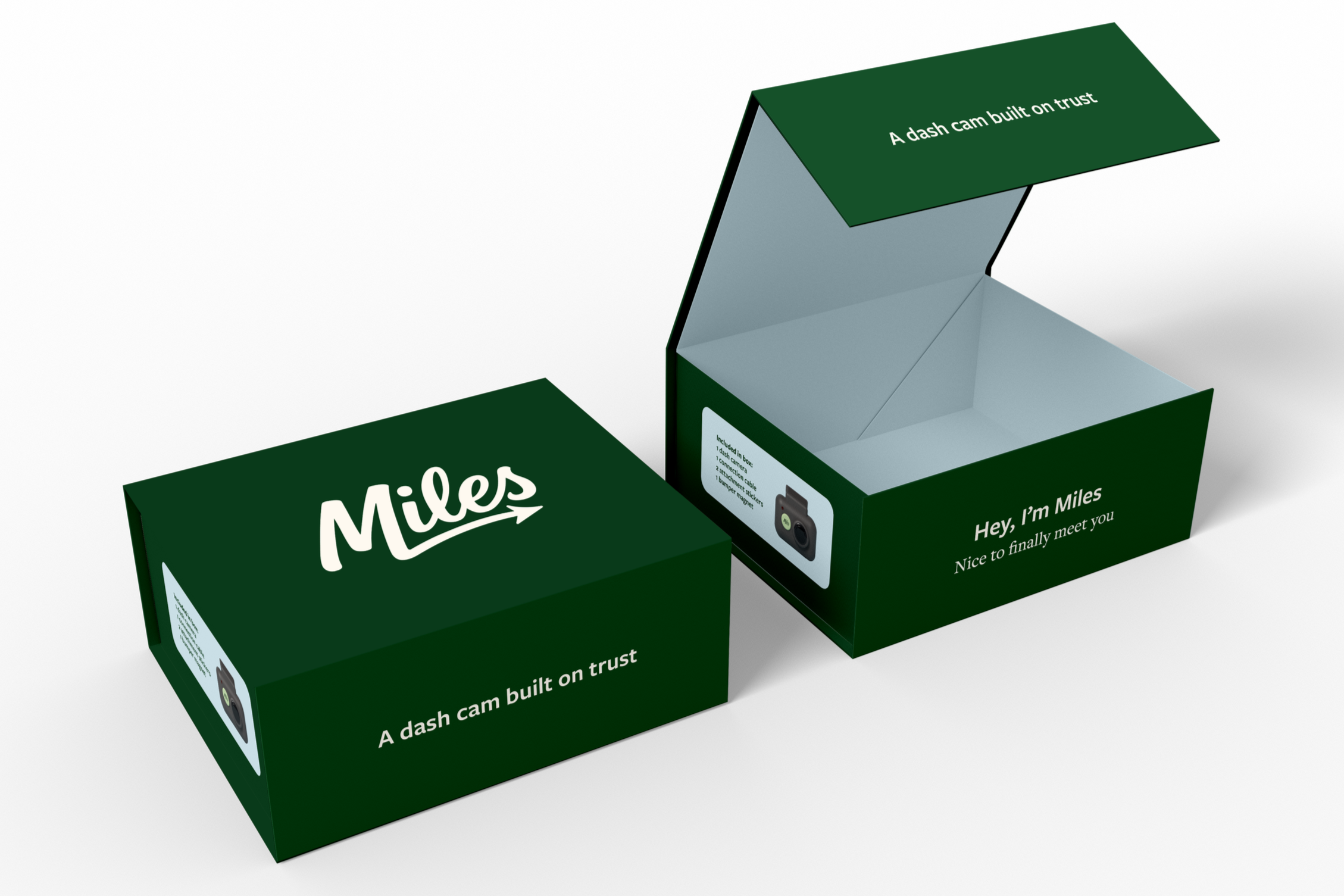 Open green box with white text, indicating it is a dash cam for Miles, inside and partially opened, with a logo that says "Miles" on the outside of the box.