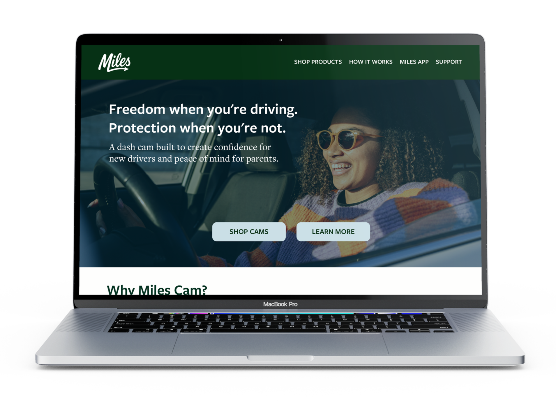 Laptop displaying a website for Miles Dash Cam company, with the tagline "Freedom when you're driving. Protection when you're not" and a picture of a teen with curly hair smiling while driving, wearing sunglasses.