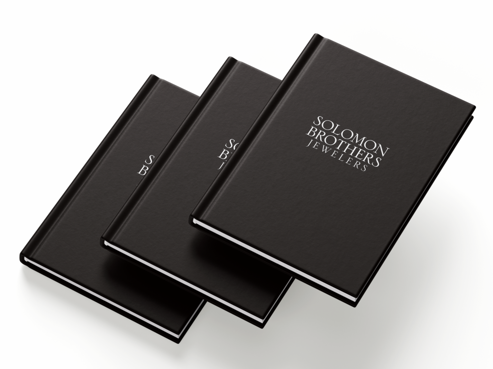 Three black books stacked, displaying the text "Solomon Brothers Jewelers" in white.