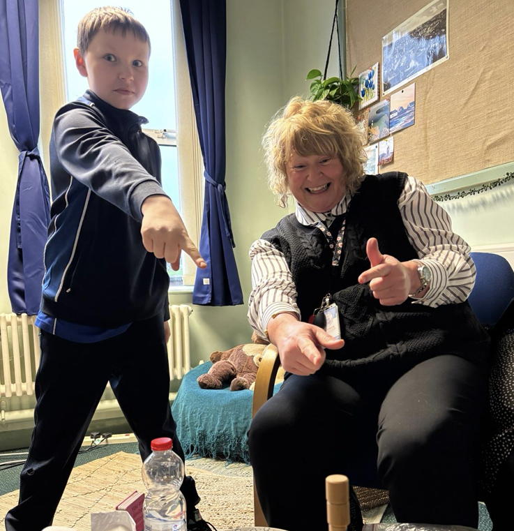 Classroom assistant and child having fun