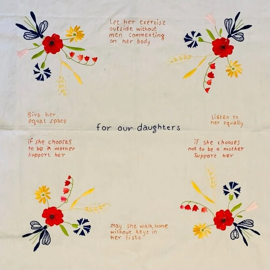 Subversive stitching, socially engaged art, feminist project about everyday sexism, artist Sharon Douglas , tablecloth with hopes for daughter