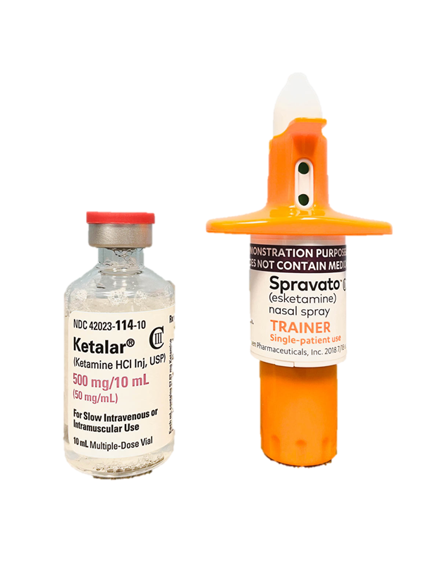 A small clear vial labeled Ketalar and a nasal spray bottle labeled Spravato (esketamine) nasal spray on a plain background.