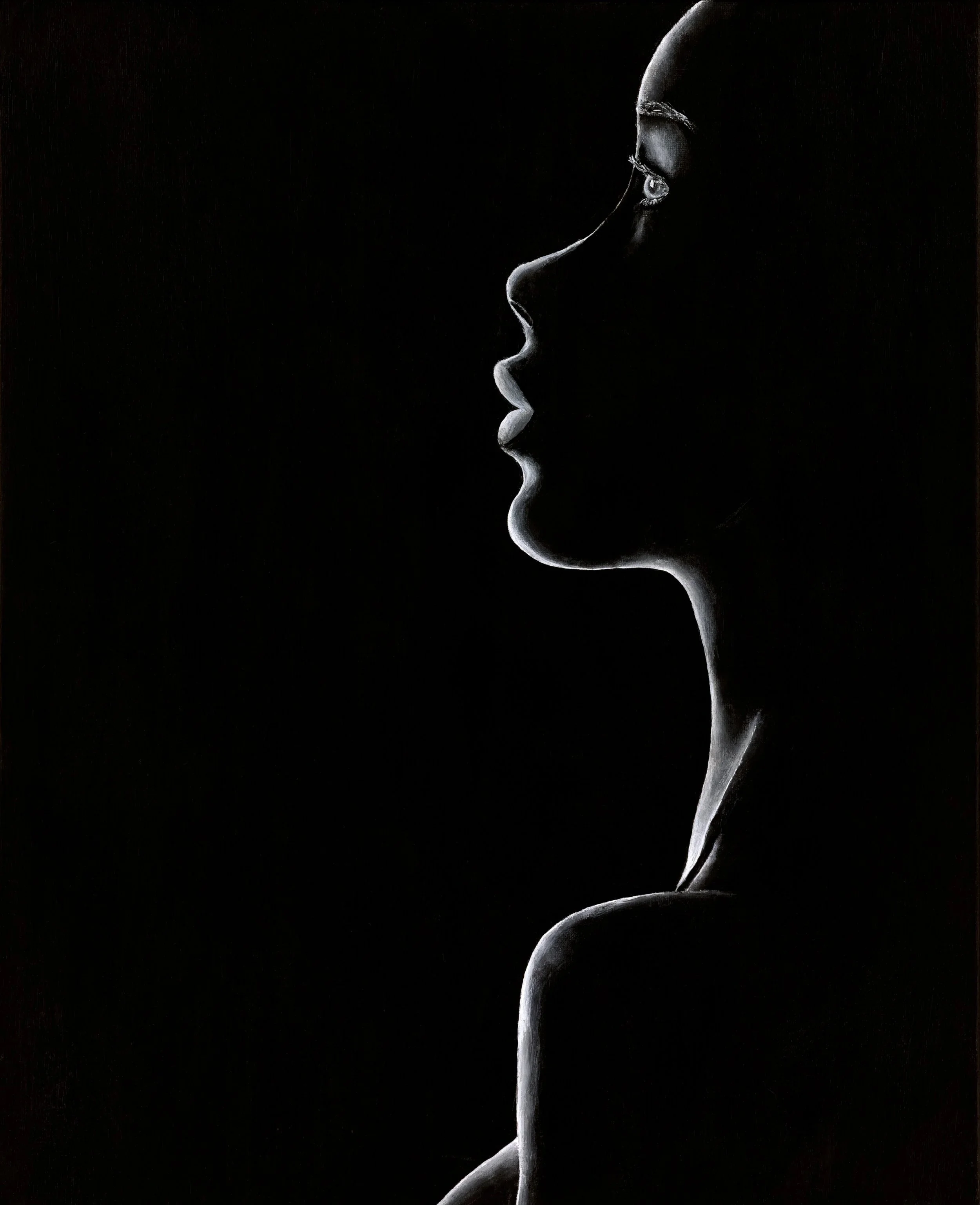 Silhouette of a woman's profile in black and white, highlighting her facial features and shoulder against a dark background.