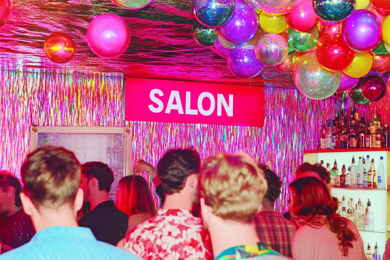 a_disco_party_with_a_sign_that_has_the_letters_AI_SALON_--ar__6ec482c6-695f-4ff5-a92d-52f60e16c5e5_3.png