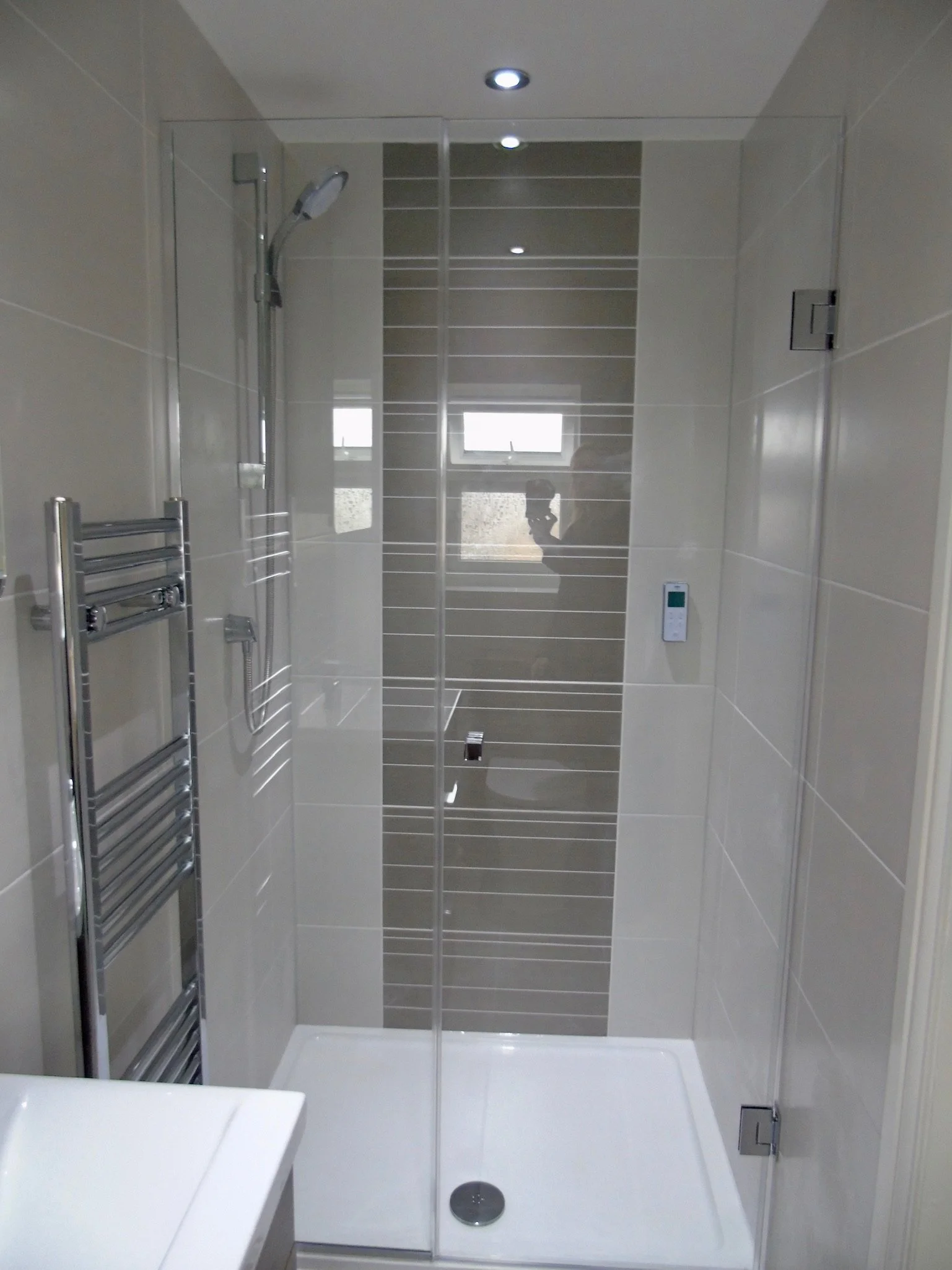 Digital shower with low profile tray and bespoke frameless screen and door