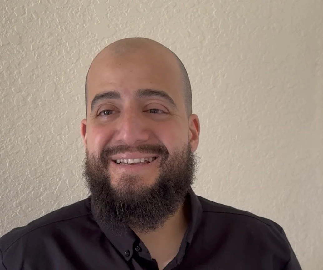 Portrait of a smiling man, Dr. Elkady, with over a decade of medical experience in different clinical settings. He hopes to reflect kindness and compassion towards his future patients and maintain integrity.