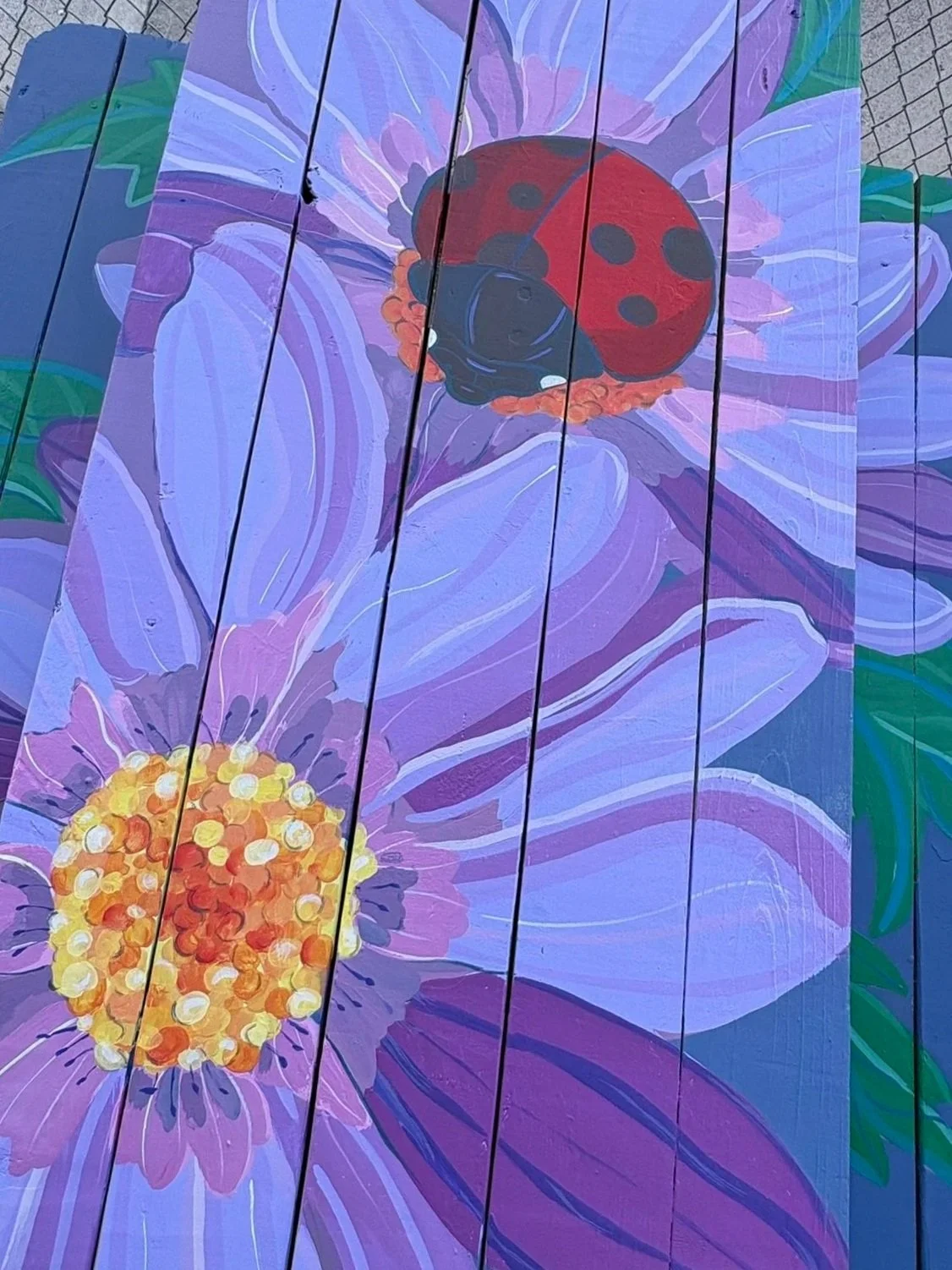 Surrounded by royal purple flowers, this ladybug honors the life of Lexee Kianna, a  beautiful girl whose life continues to bloom in the hearts of those who love her. This table is dedicated to my dear friend & her family .