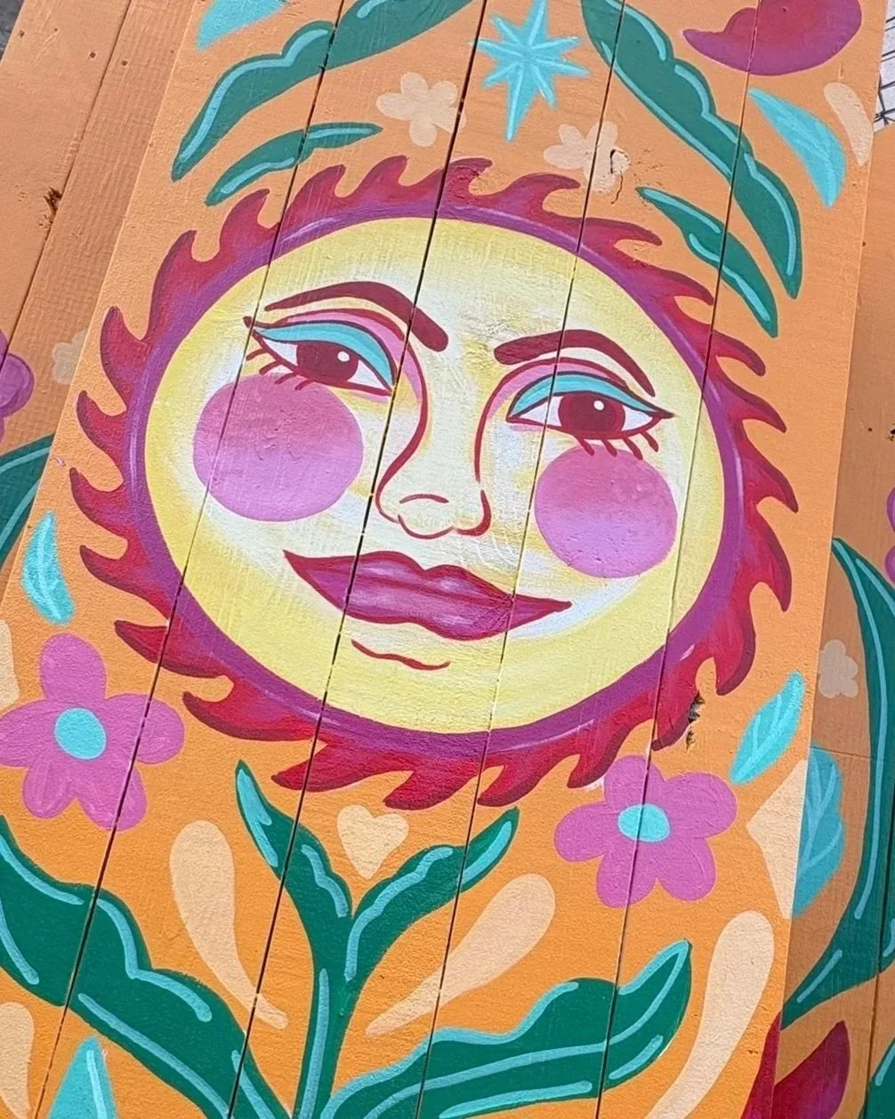 This smiling sun celebrates the one thing shining over all of us. No matter who we are or where we come from, we share it's warmth & light.