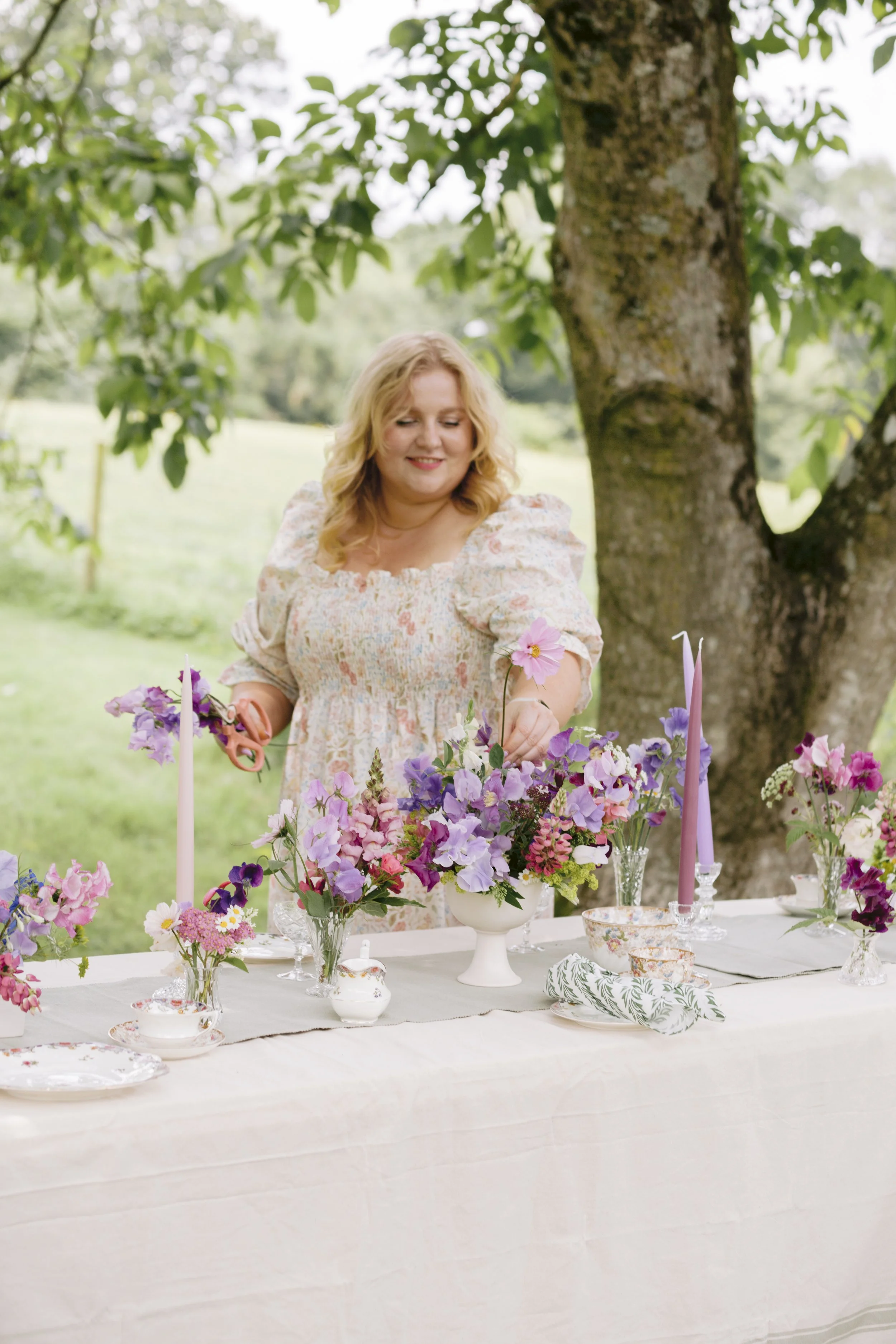 Wiltshire wedding florist working with seasonal flowers in countryside setting