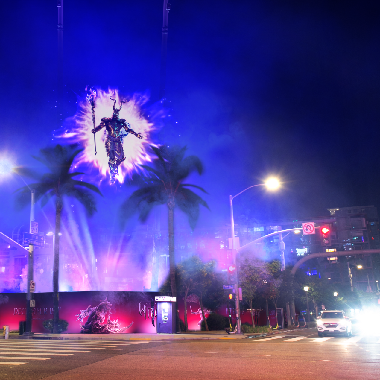 An illuminated city street at night with a large fantasy-themed advertisement on a building. The ad features a figure with horns, floating with a glowing purple aura, with palm trees and cars visible below.