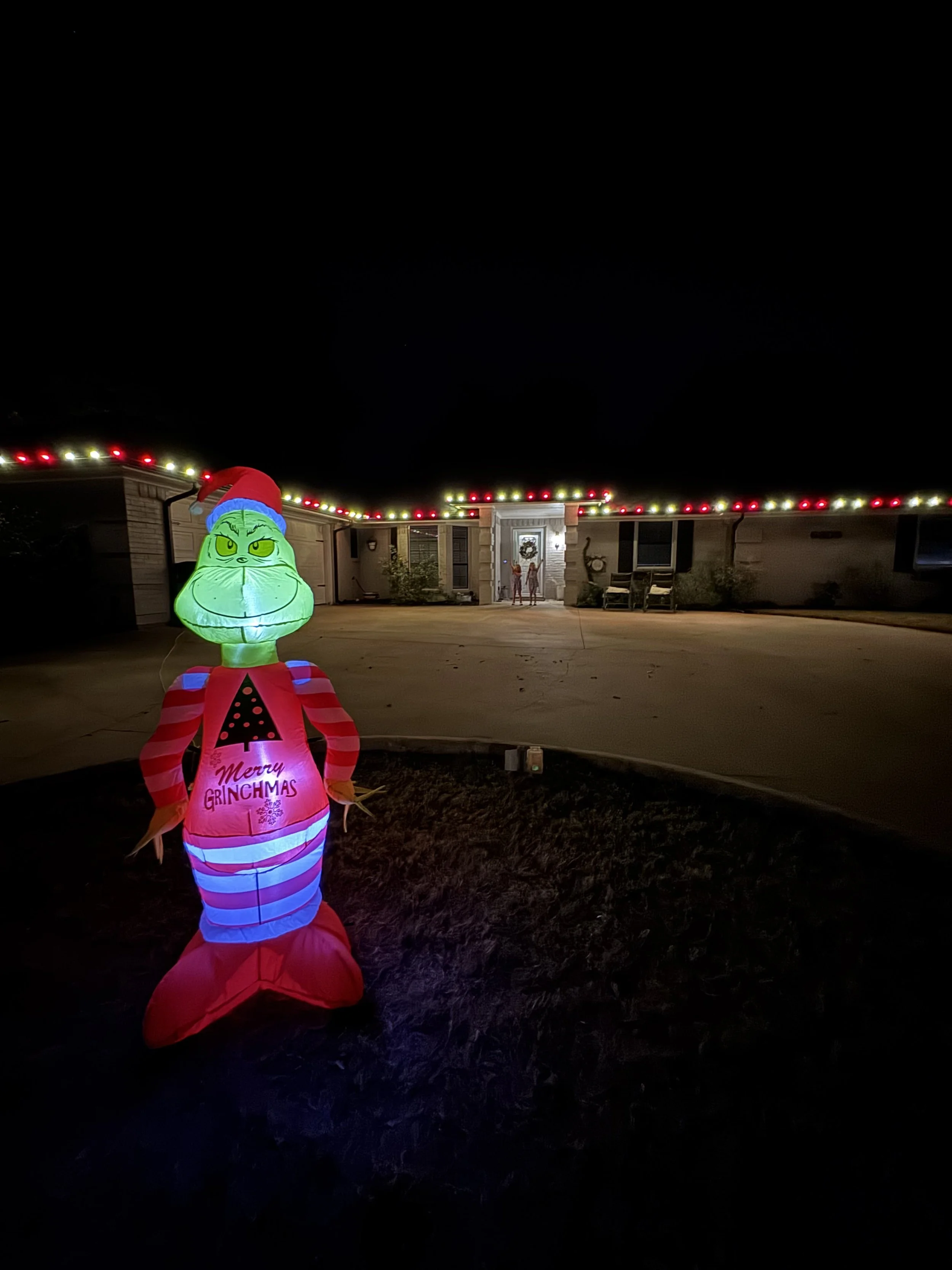 Residential Christmas light installation in Granbury Texas. Red and warm white roofline lighting by Bearded Elf Co.