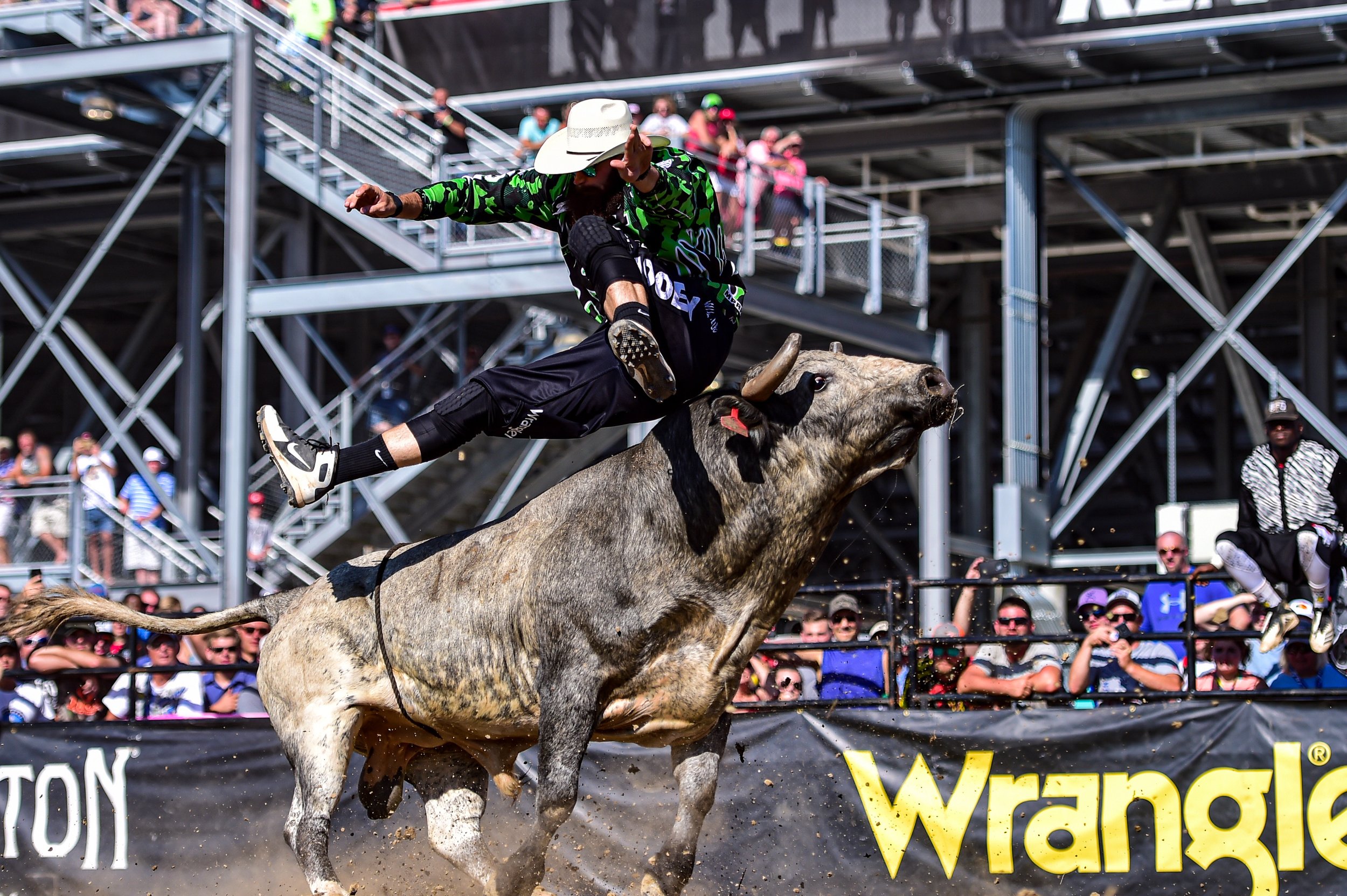 Weston Rutkowski 4x BFO World Champion freestyle bullfighter jumping over bull at professional rodeo — Founder of Bearded Elf Co. Granbury Texas