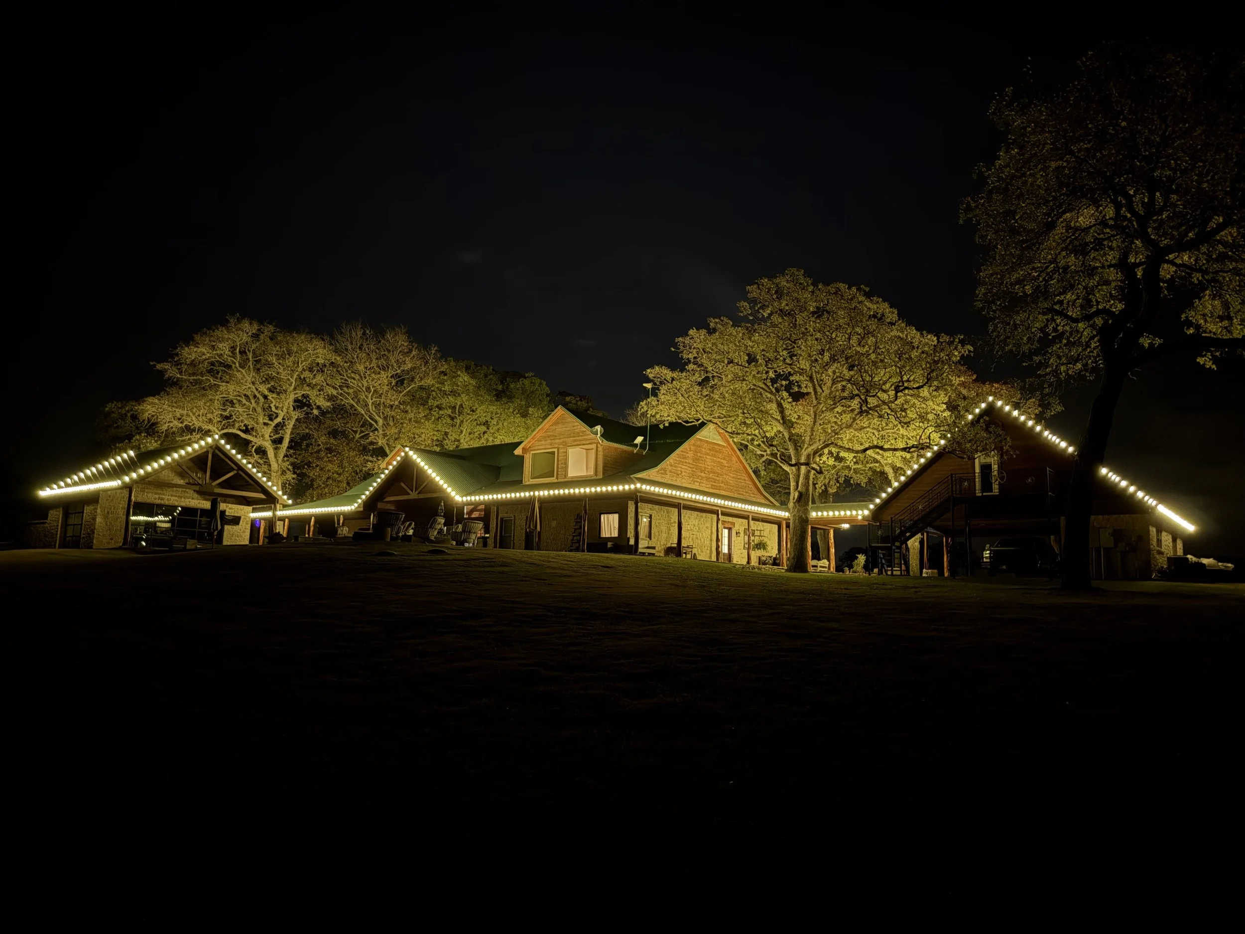 Christmas light installation on a large ranch property in Weatherford, Texas. Full roofline and ridgeline lighting by Bearded Elf Co.