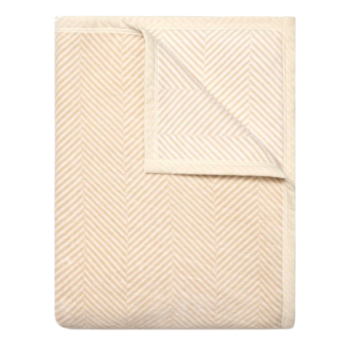 A neatly folded beige bedsheet with a subtle chevron pattern.