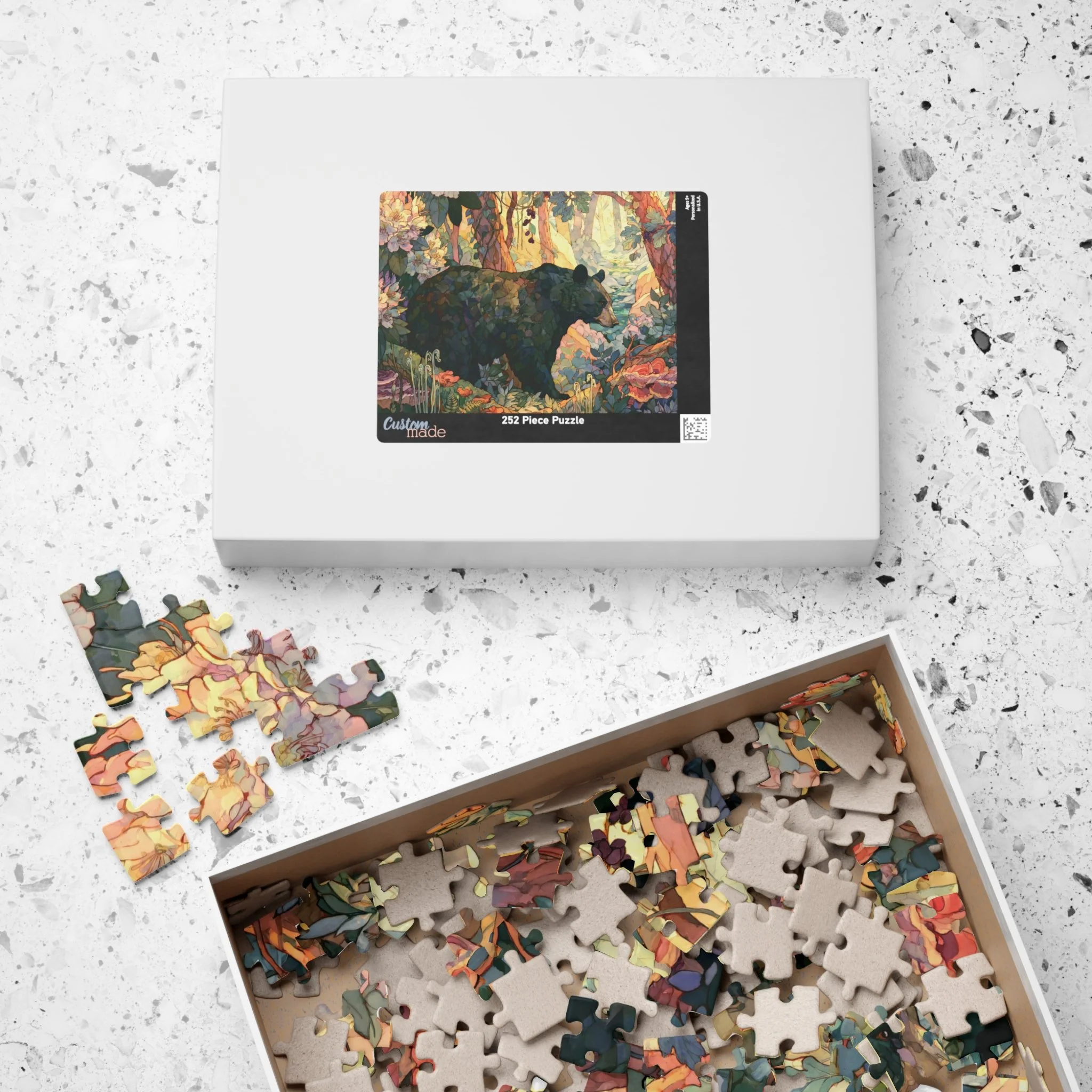 Black Bear Forest puzzle shown with box and pieces on a tabletop, featuring painterly Appalachian black bear artwork