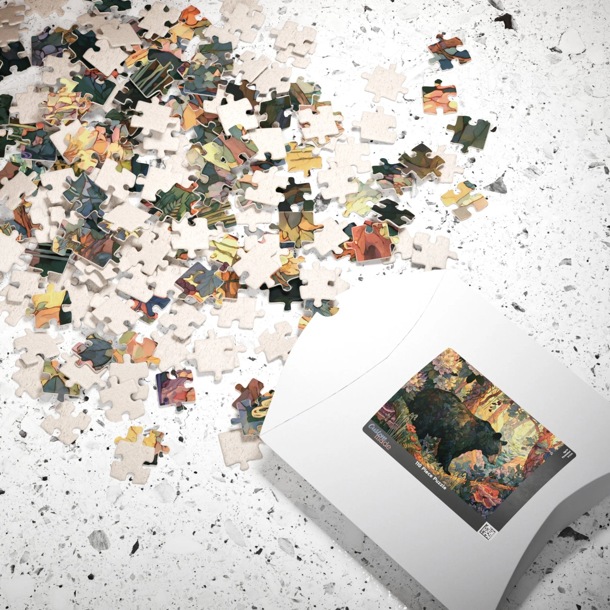 Black Bear Forest puzzle shown with box and pieces on a tabletop, featuring painterly Appalachian black bear artwork