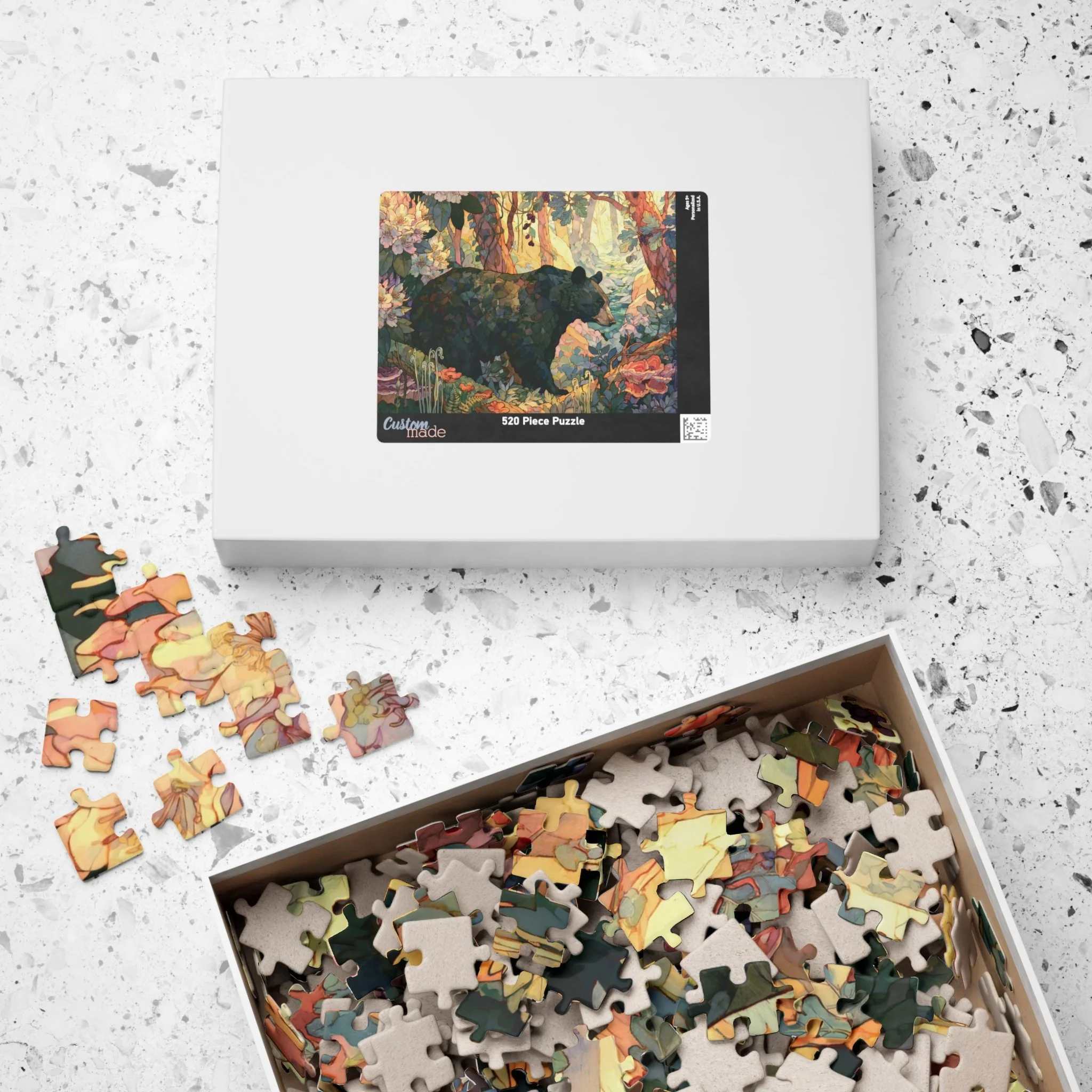 Black Bear Forest puzzle shown with box and pieces on a tabletop, featuring painterly Appalachian black bear artwork