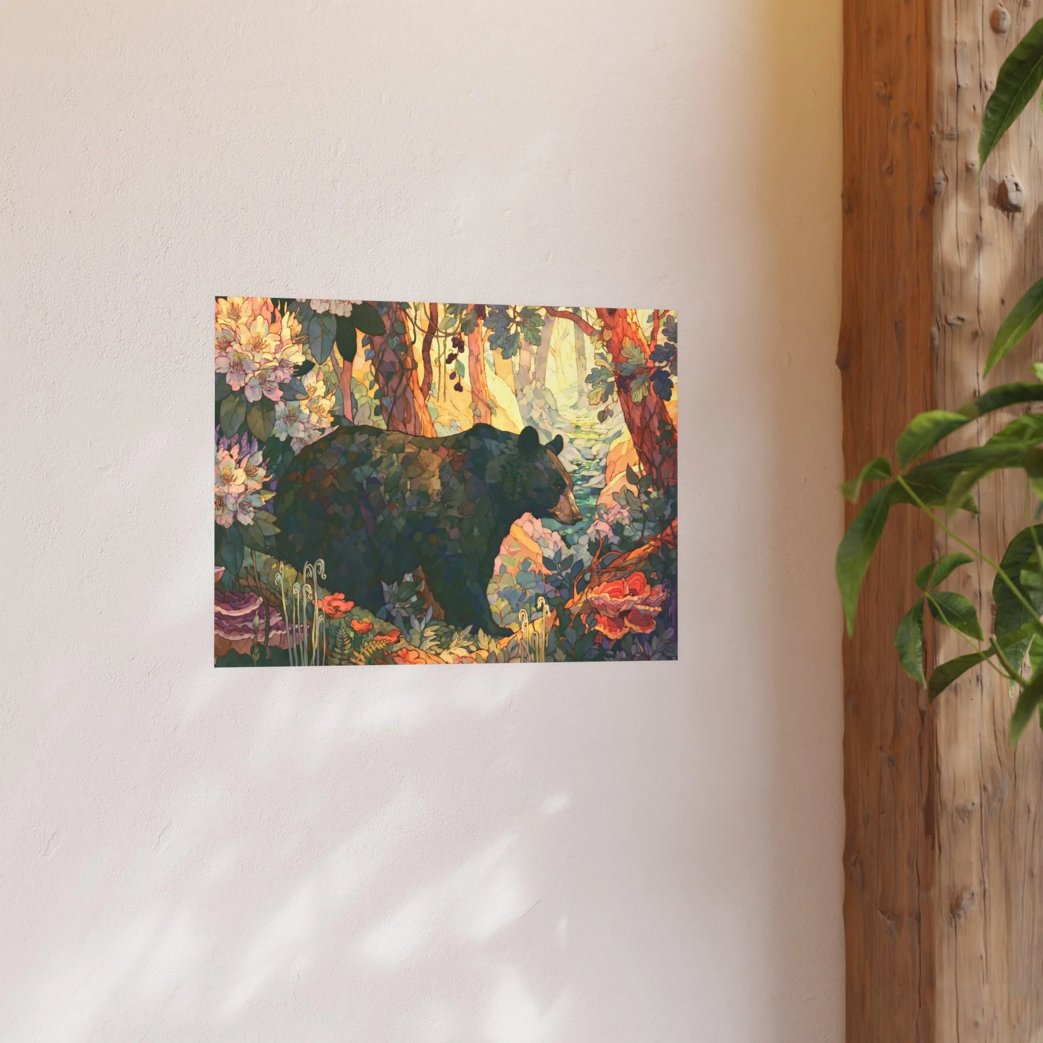 Black Bear Forest 24 x 18 art print displayed on a light wall beside a wood shelf and green plant