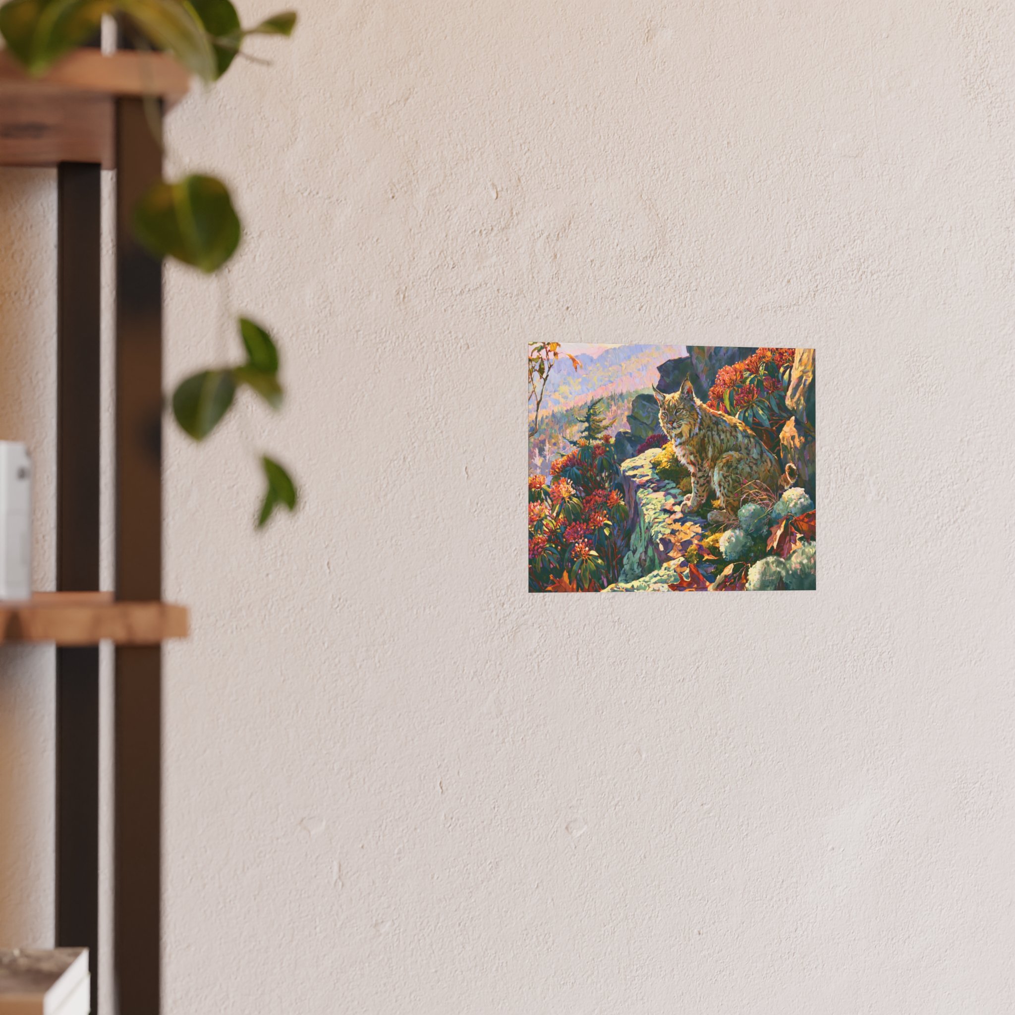 Wildcat Over the Gorge 10 x 8 bobcat art print displayed on a light wall beside a wood shelf and green plant
