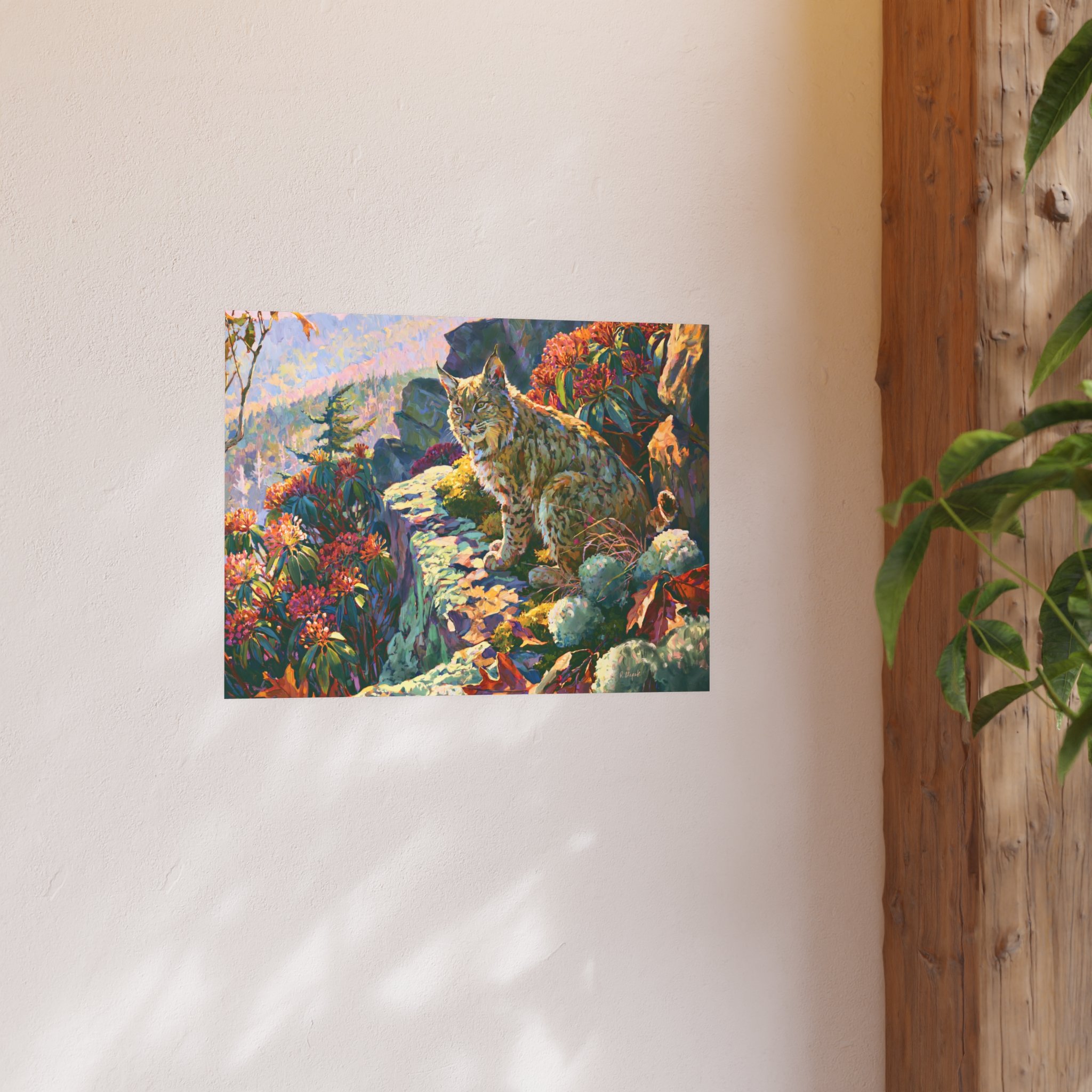 Wildcat Over the Gorge 24 x 18 bobcat art print displayed on a light wall beside a wood beam and green plant
