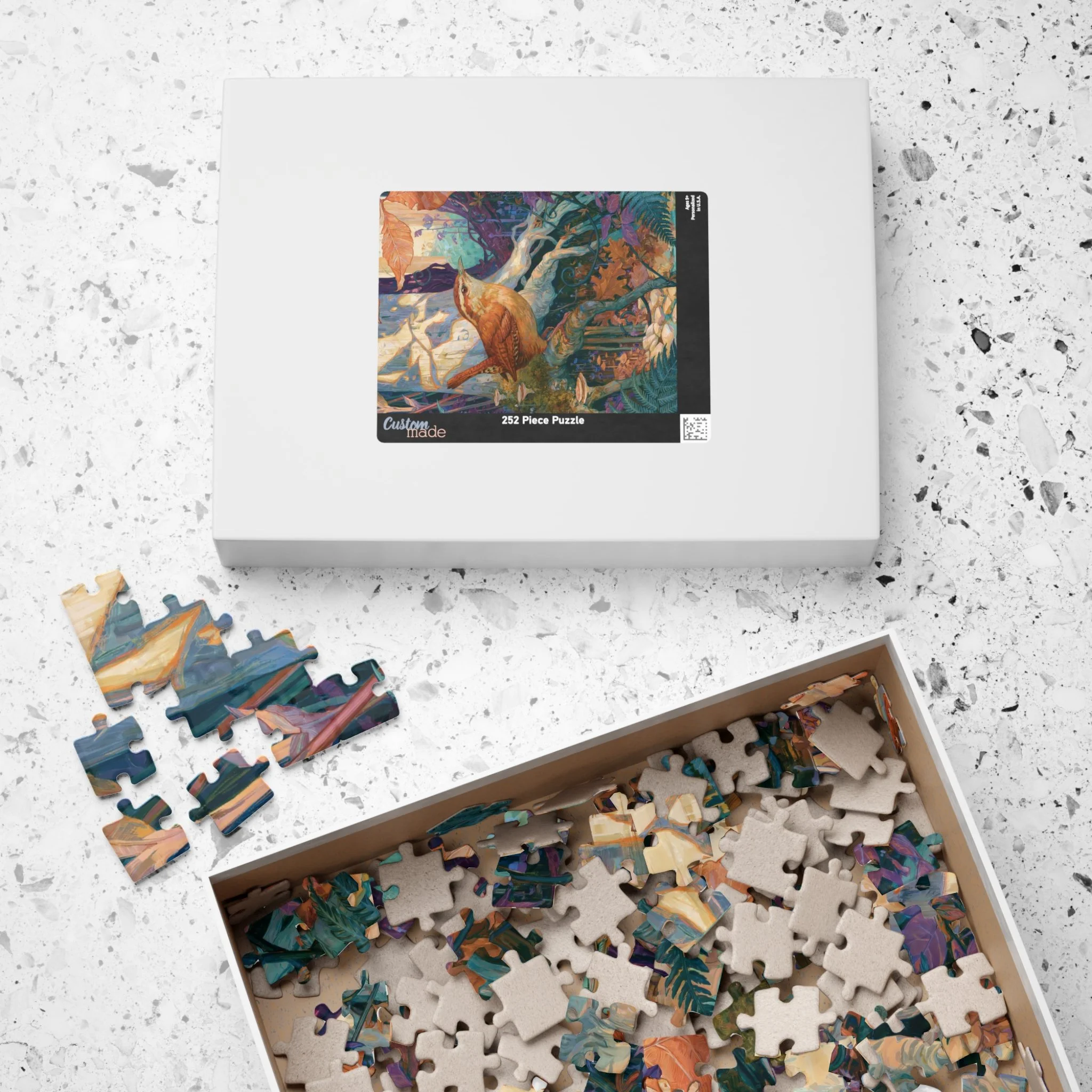 Carolina Wren in the Beech Roots puzzle with its paper box featuring the complete artwork by Rachel Stepek.