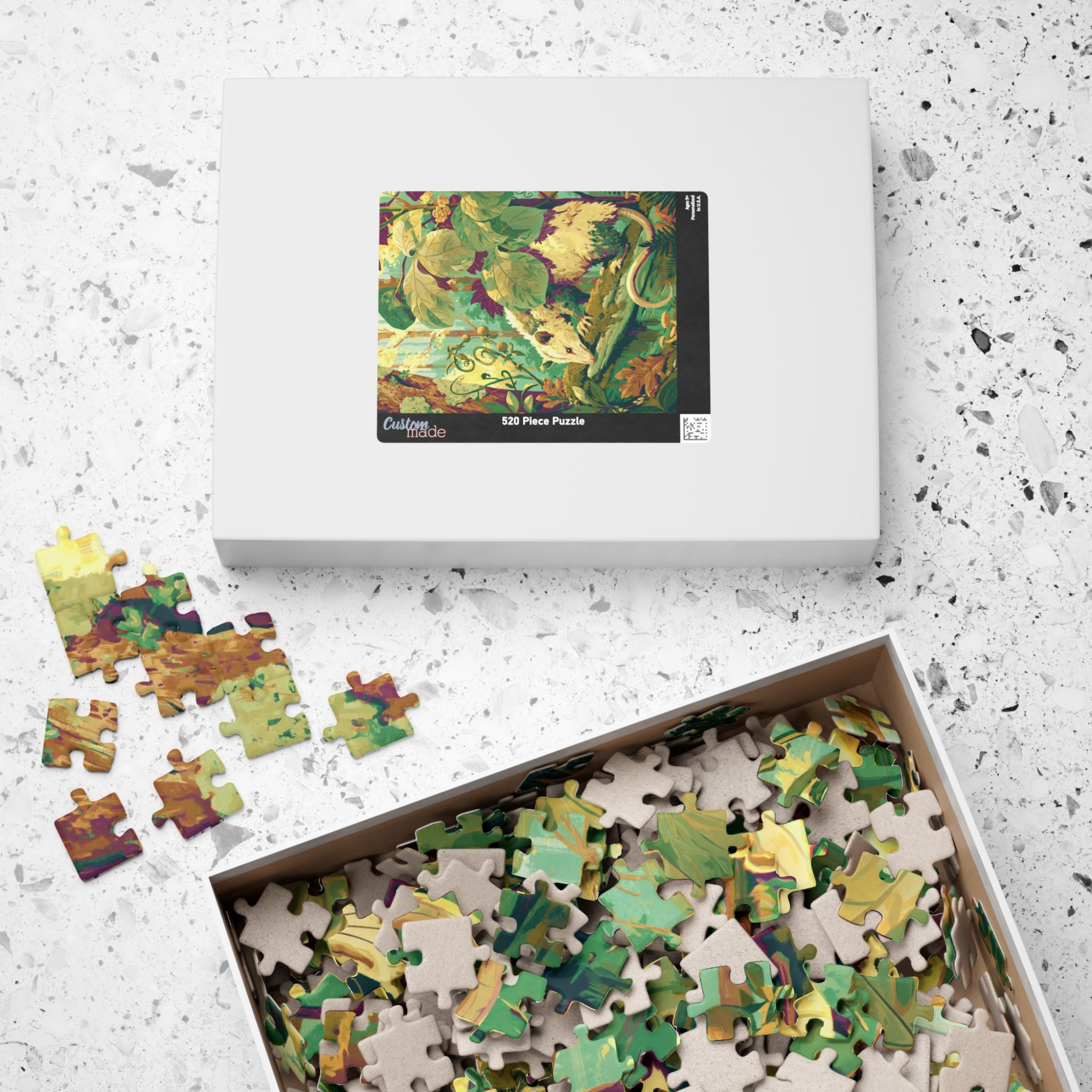 Opossum on the Mossy Log jigsaw puzzle with its paper box and reference print featuring the complete Virginia opossum artwork by Rachel Stepek.