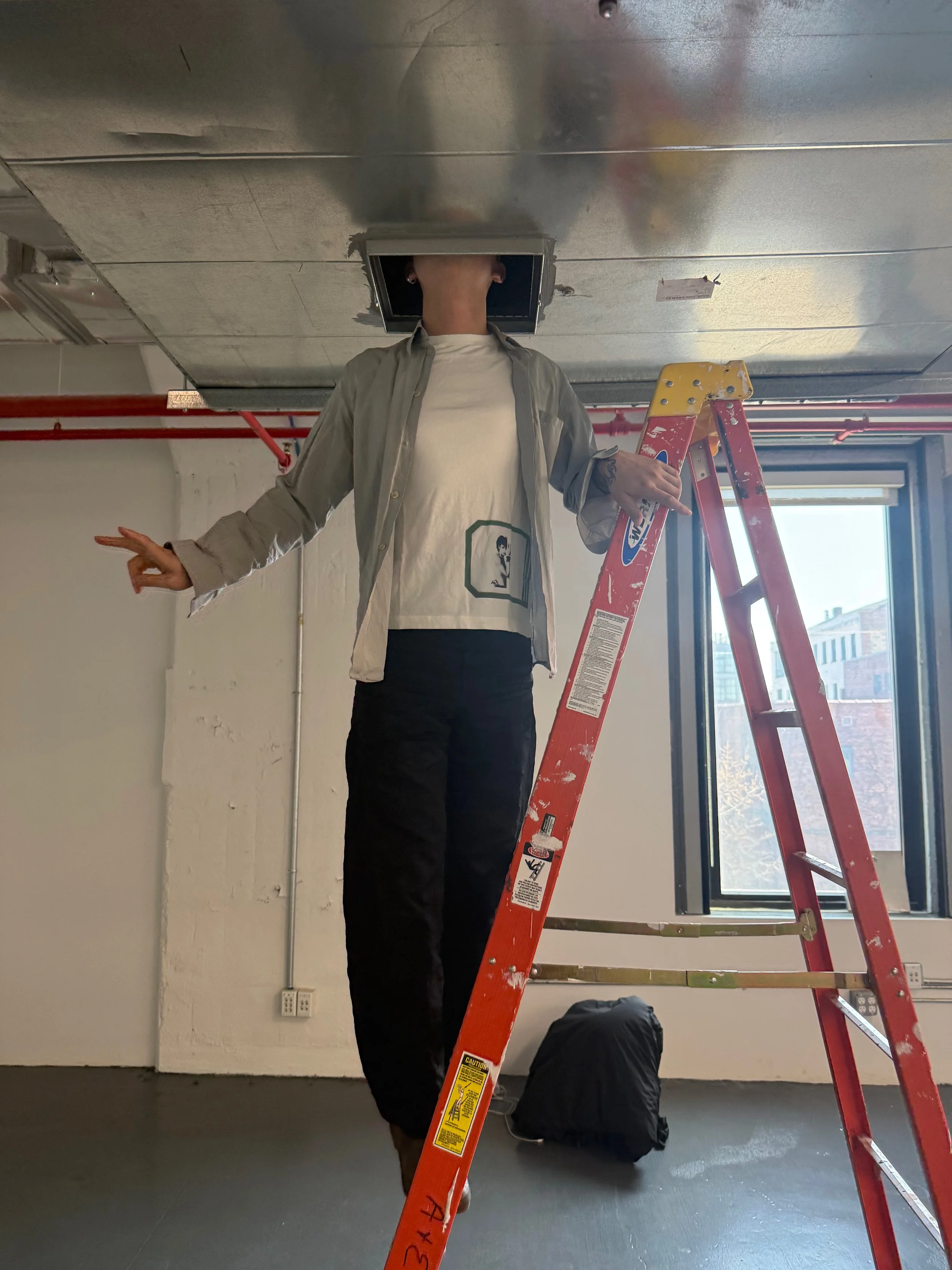 Artist preparing installation in The Gallery space, Brooklyn, using ladder and ceiling access