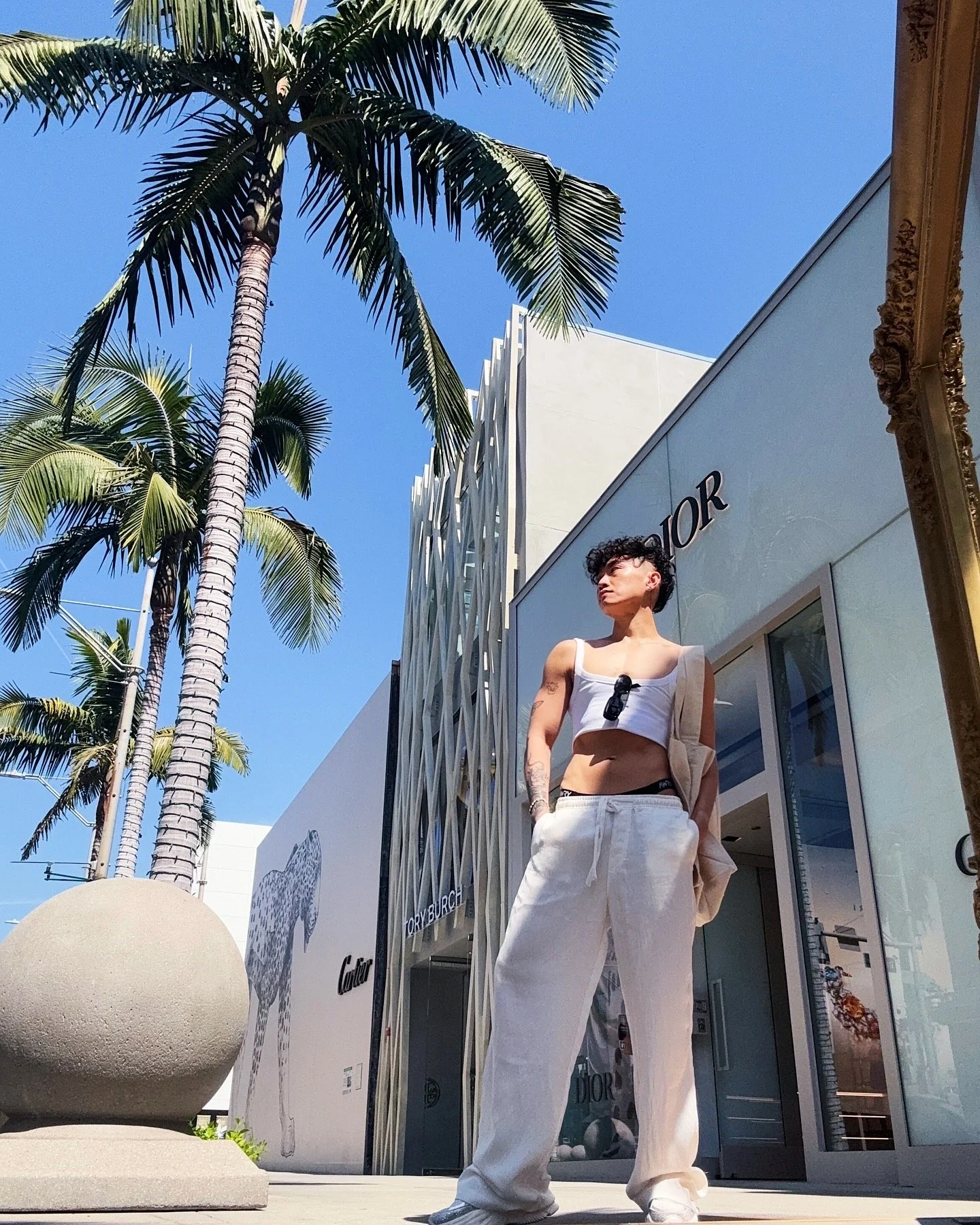 AJ Harley in Los Angeles Rodeo Drive wearing a monochrome white look outside Dior.