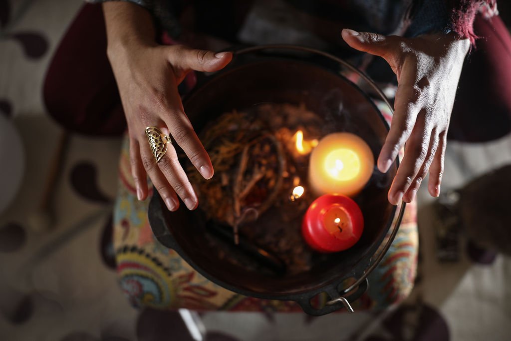 A spiritual and intuitive development ritual with metaphysical reverend clarissa. Candles lit with sage and incense in a cast iron cauldron.
