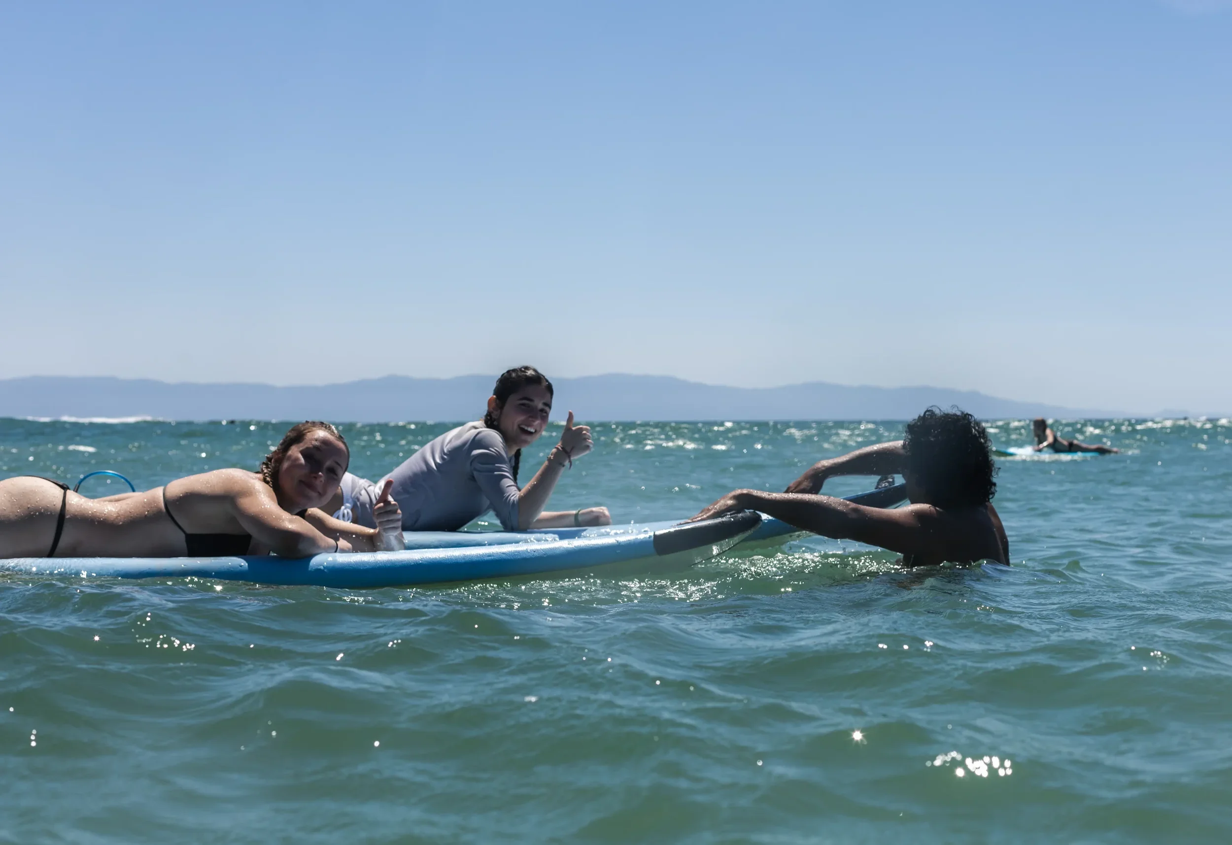 Surf students on a soft board in the ocean at Sayulita