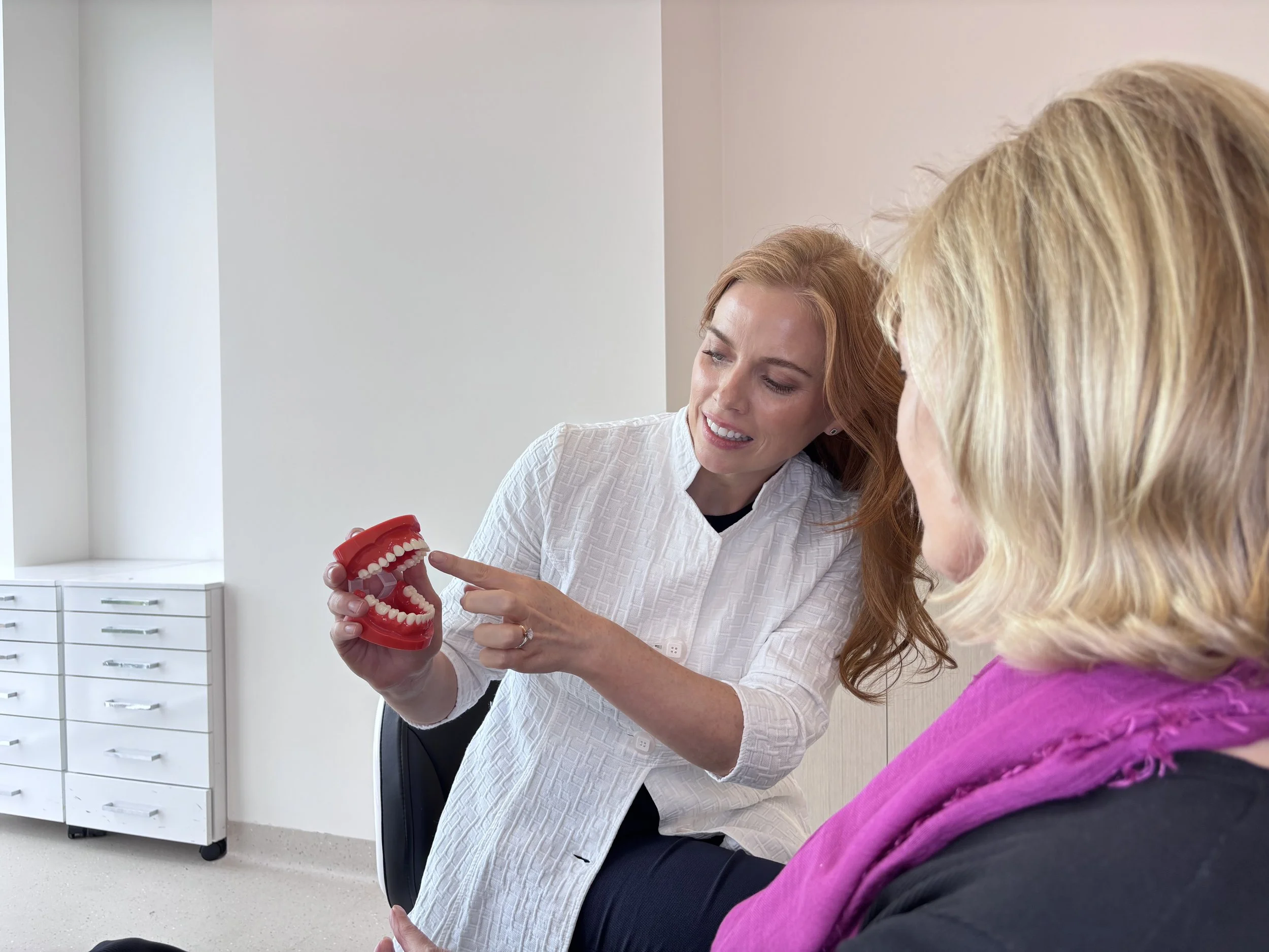 Dr Aimee Dunne showing a dental model during consultation