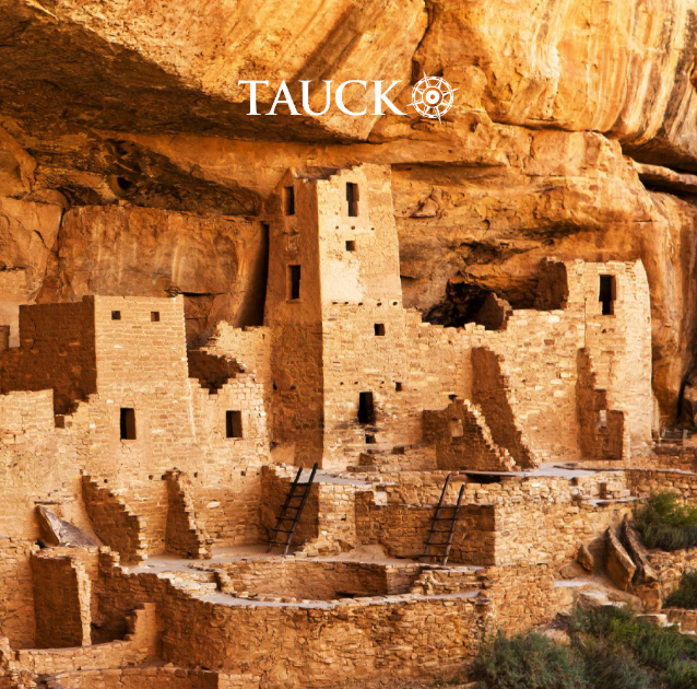 Ancient Ancestral Puebloan cliff dwellings built into a rocky cliff face in Tauck travel promotion.