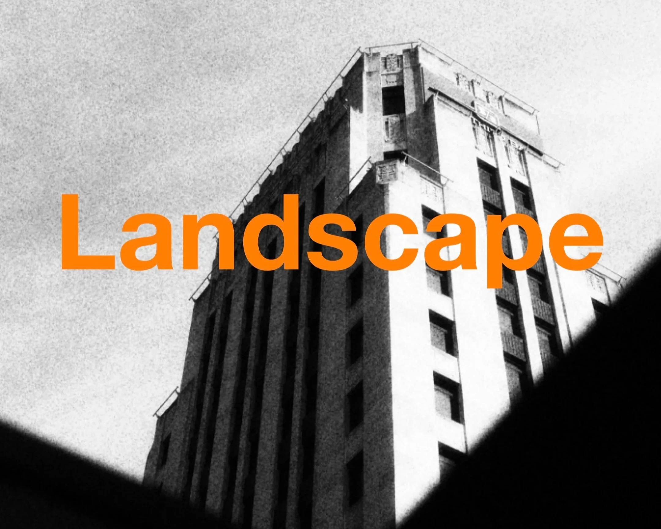 A black and white image of a tall residential building viewed from a low angle, with orange text at the bottom that reads 'Landscap'.