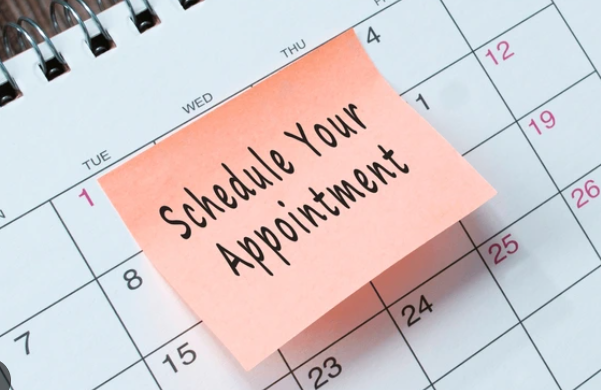 Calendar with a pink sticky note that reads 'Schedule Your Appointment.'