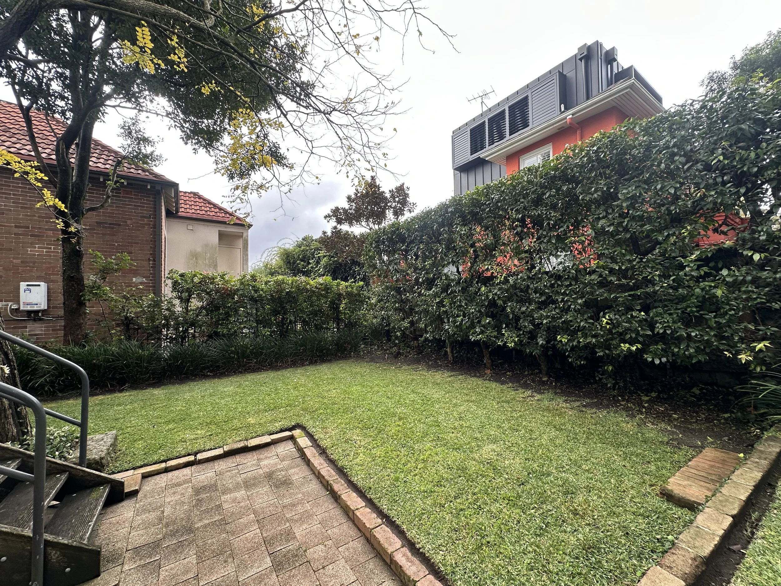 Professional lawn mowing and hedge maintenance in Woollahra by Eastside Gardens, featuring a tidy residential lawn, trimmed hedges and clean garden edges.
