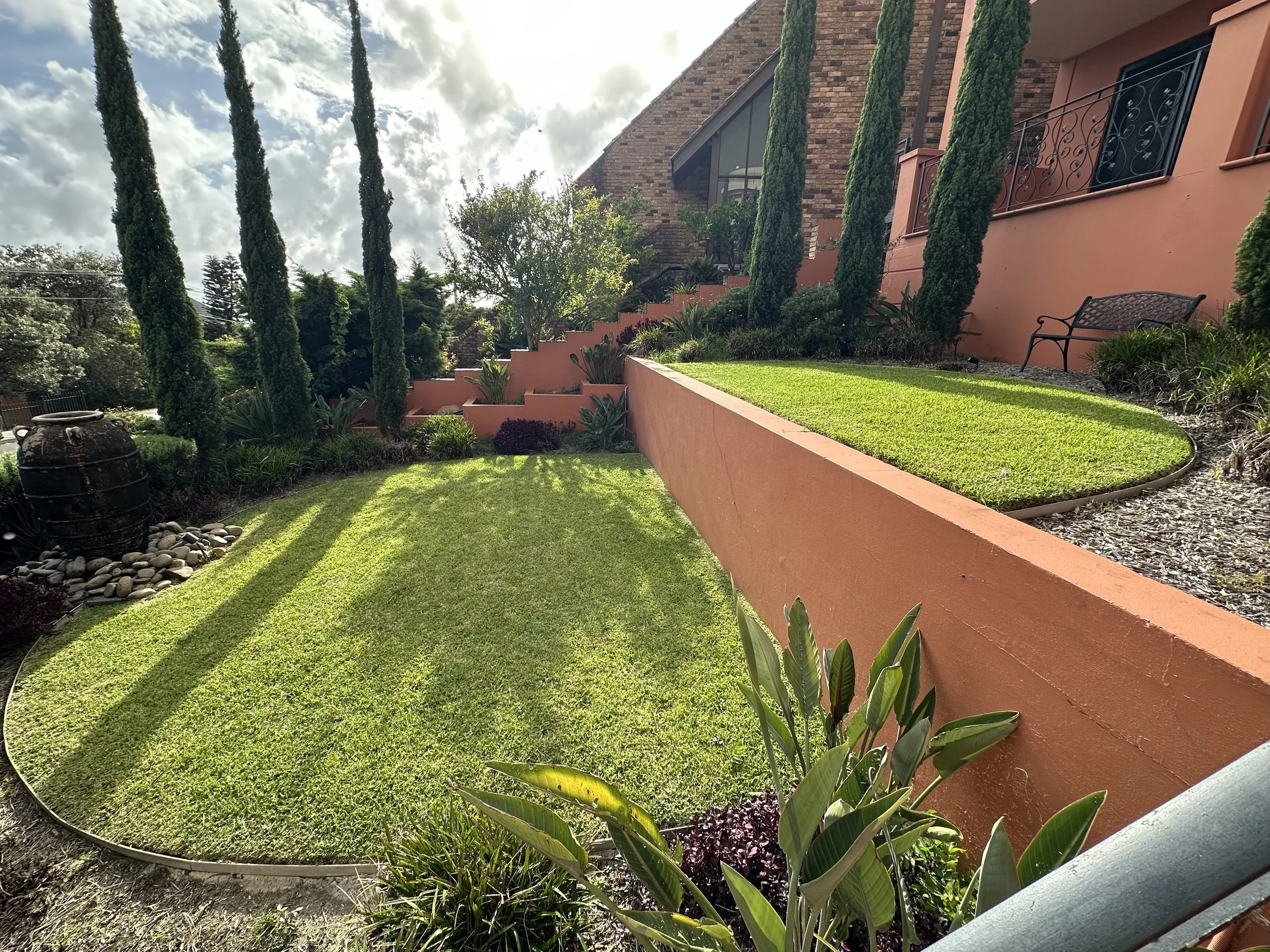 Professional lawn mowing and garden maintenance in Coogee by Eastside Gardens, featuring manicured lawns, clean garden edges and well-maintained residential landscaping.