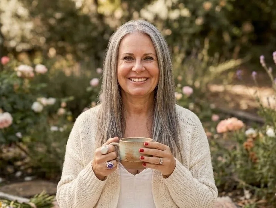 Woman holding a mug outdoors, representing calm and reflection at a women's circle retreat.