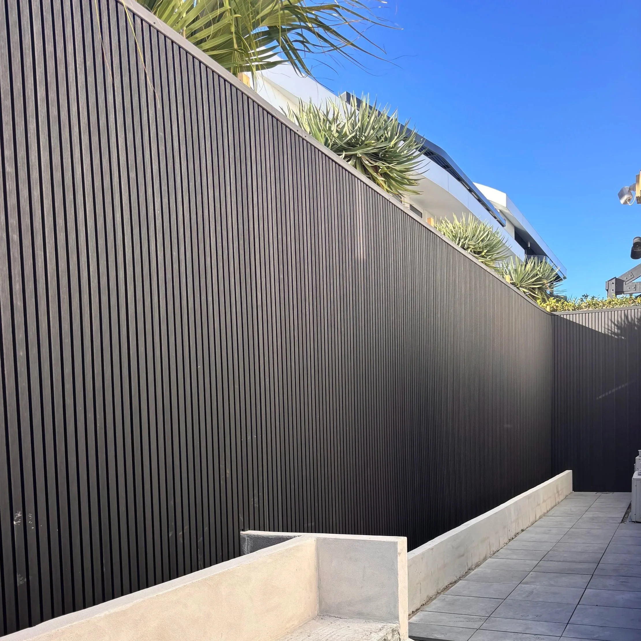 View of modern exterior cladding in a dark vertical wood slats wall in Melbounre